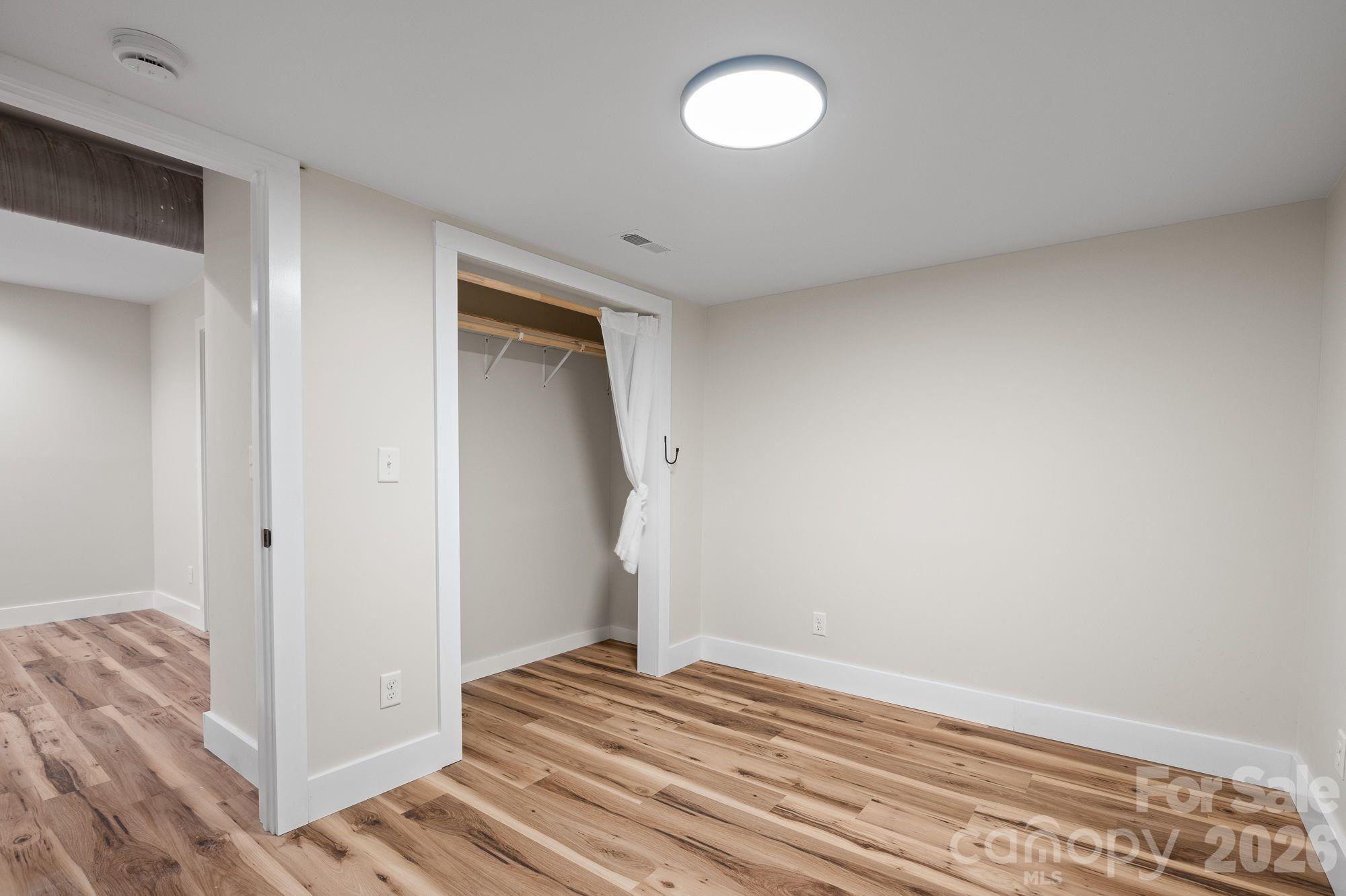 Flex Room 1: Finished flex room with closet—ideal for office or guests. - 156 State Street, Asheville