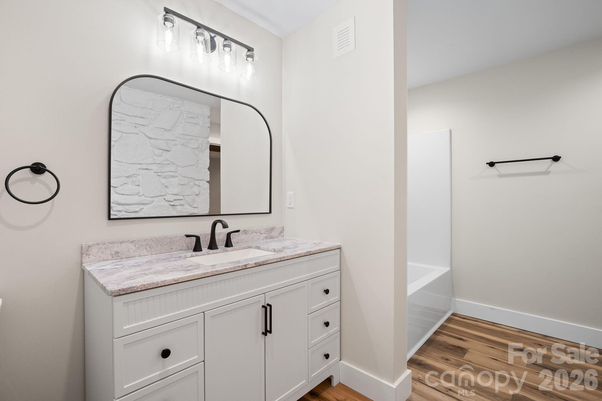 Lower-Level Bathroom: Full bathroom serving the lower-level living space. - 156 State Street, Asheville