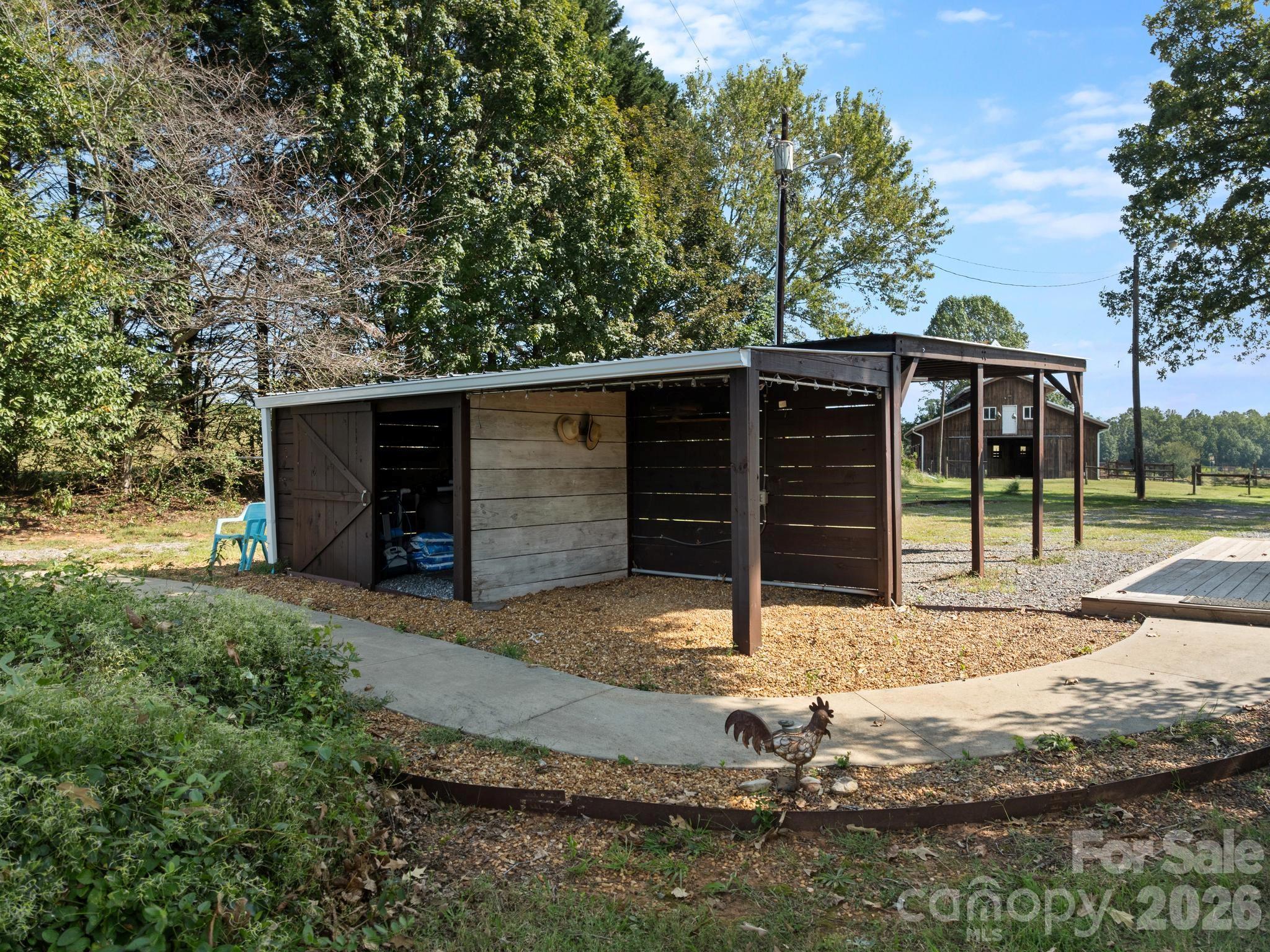 Backside of the carport is a cabana for storing equipment for the pool - 157 J A Hampton Road, Rutherfordton
