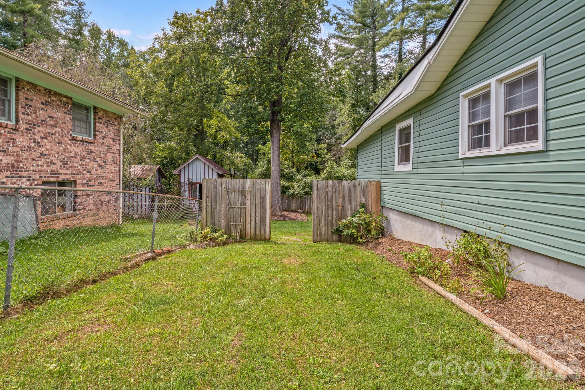 The raspberry bushes are located on either side of this gate. - 1015 Mountain View Street, Hendersonville