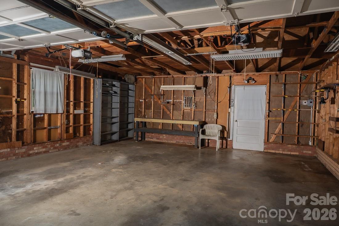 Inside the attached garage with work table - 3401 Tracelake Drive, Matthews