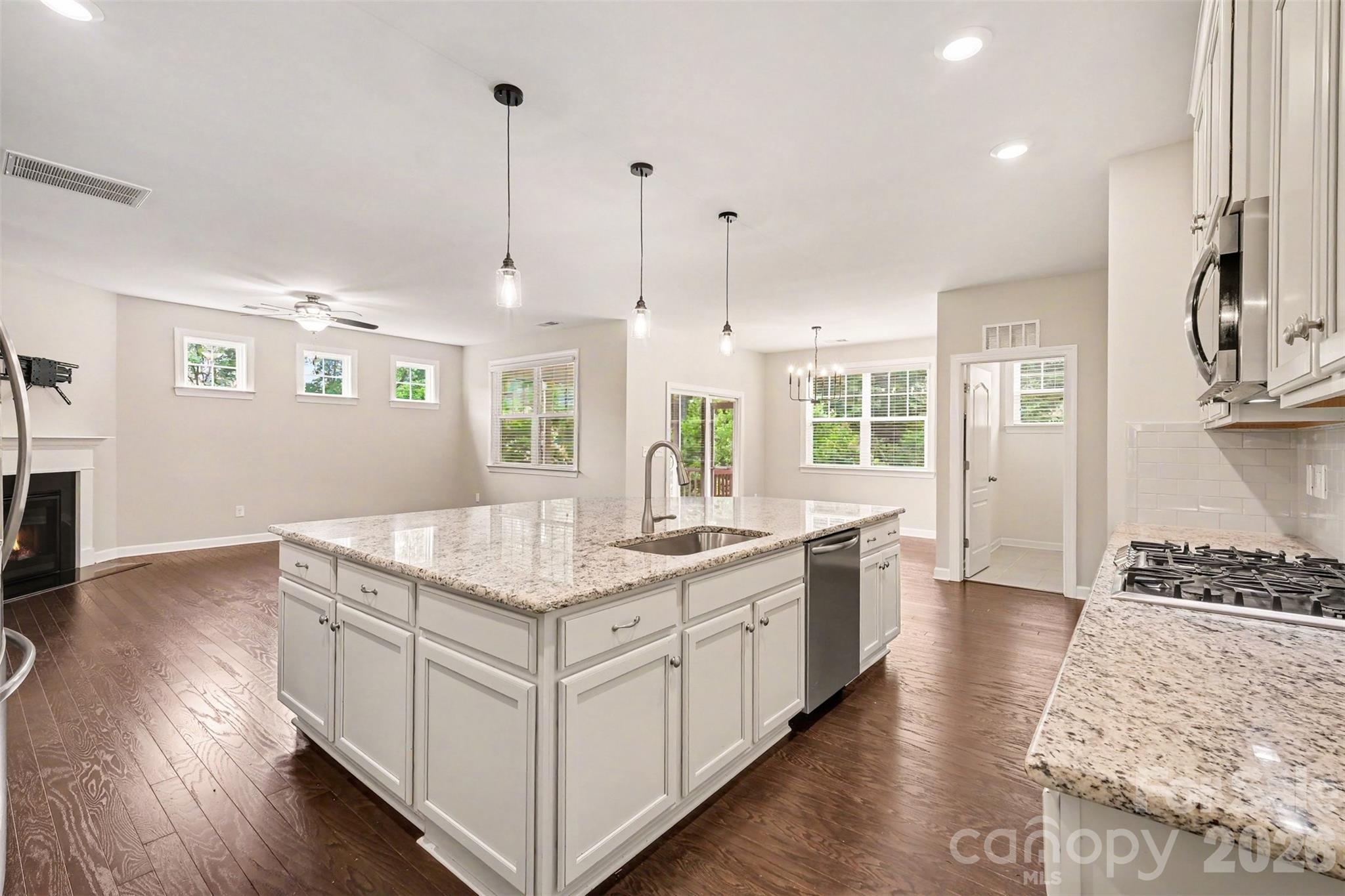 The kitchen with expansive island overlooking the family room and breakfast area - 2521 Surveyor General Drive, Waxhaw