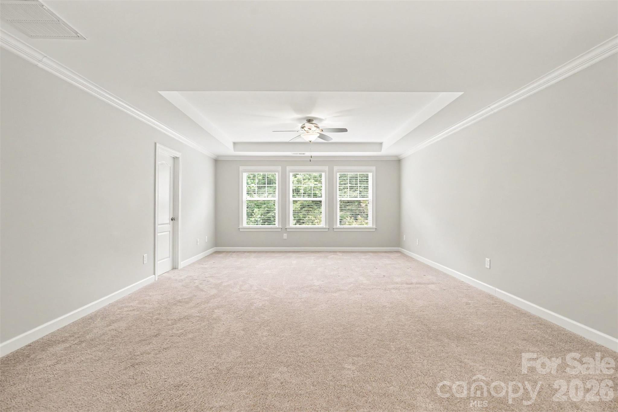 The primary bedroom overlooking the serene backyard views - 2521 Surveyor General Drive, Waxhaw