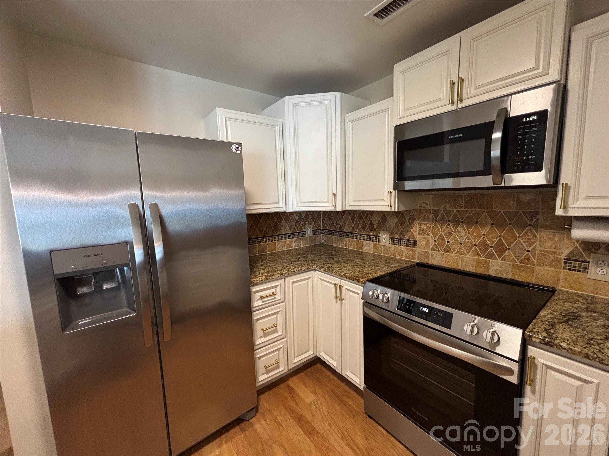 Kitchen with a new suite of Frigidaire appliances - 1332 Torrence Circle, Davidson