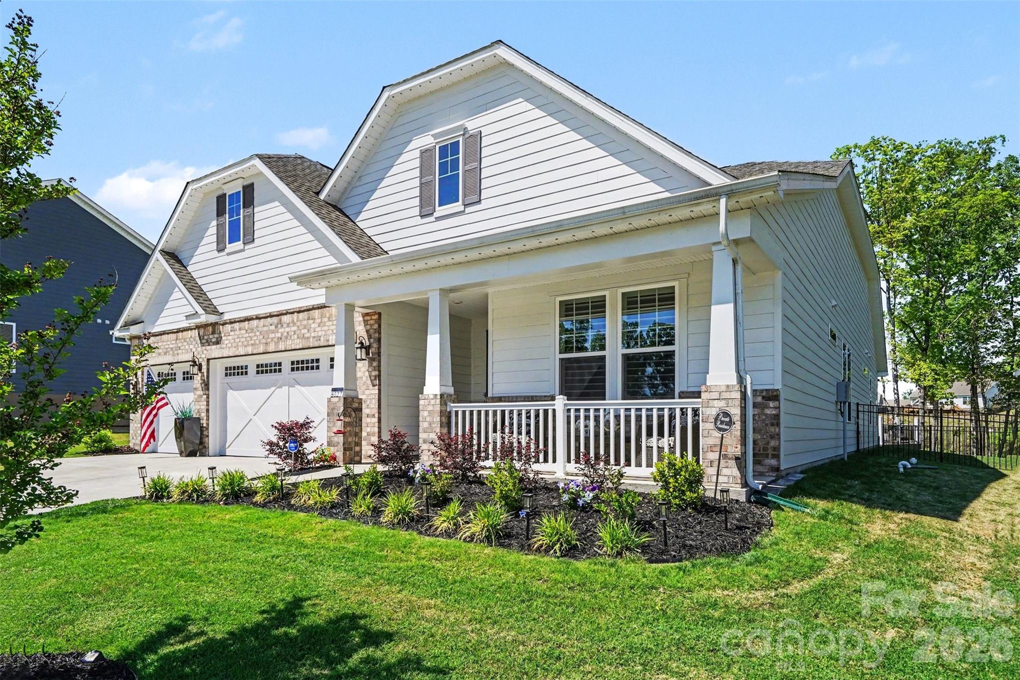 Covered rocking chair front porch, landscaped beds, and lawn care handled by the HOA. - 8027 Longwaters Court, York