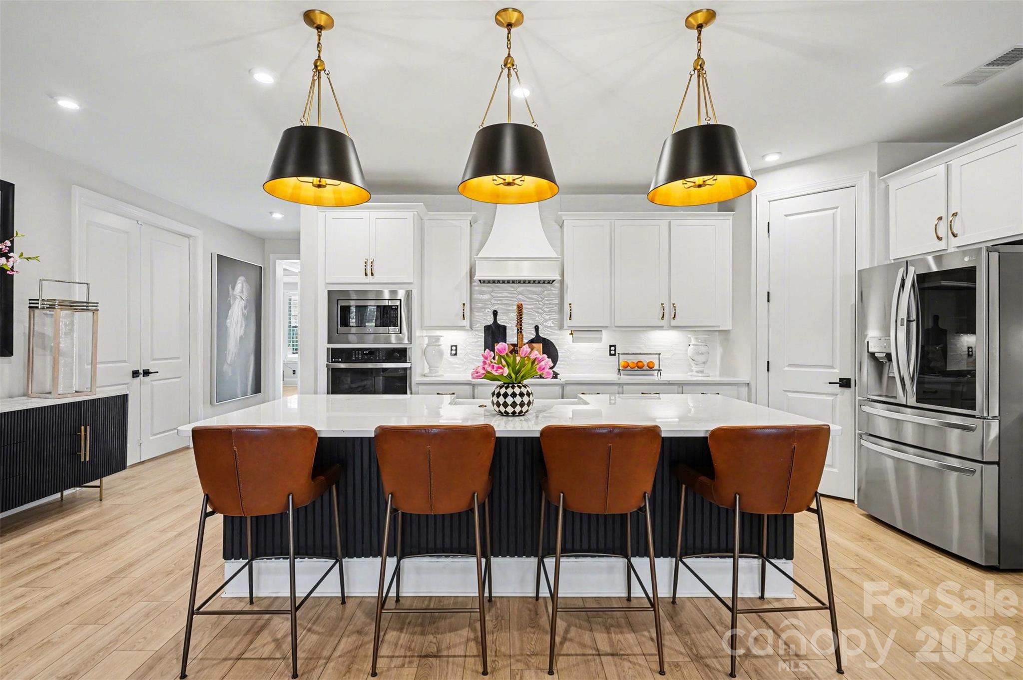 Quartz counters, an oversized island, and a walk-in pantry. The kitchen is where everyone ends up. - 8027 Longwaters Court, York