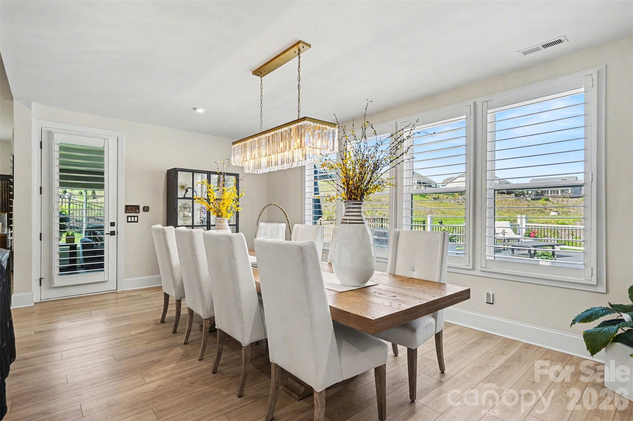 Big windows and a view of the deck from the dining area. - 8027 Longwaters Court, York