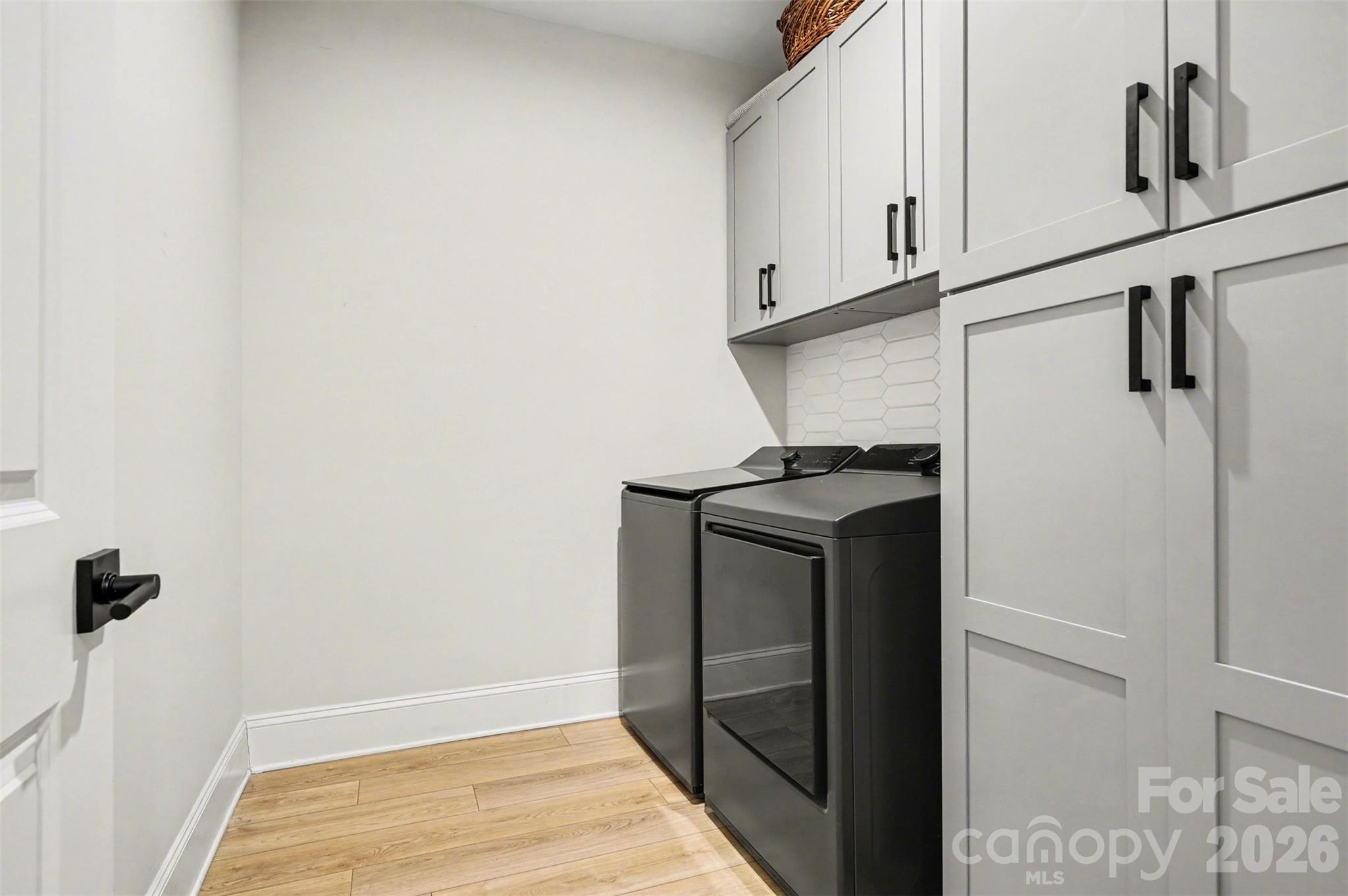 Cabinets floor to ceiling keep supplies out of sight, so the laundry room always looks neat, even on a busy laundry day. - 8027 Longwaters Court, York