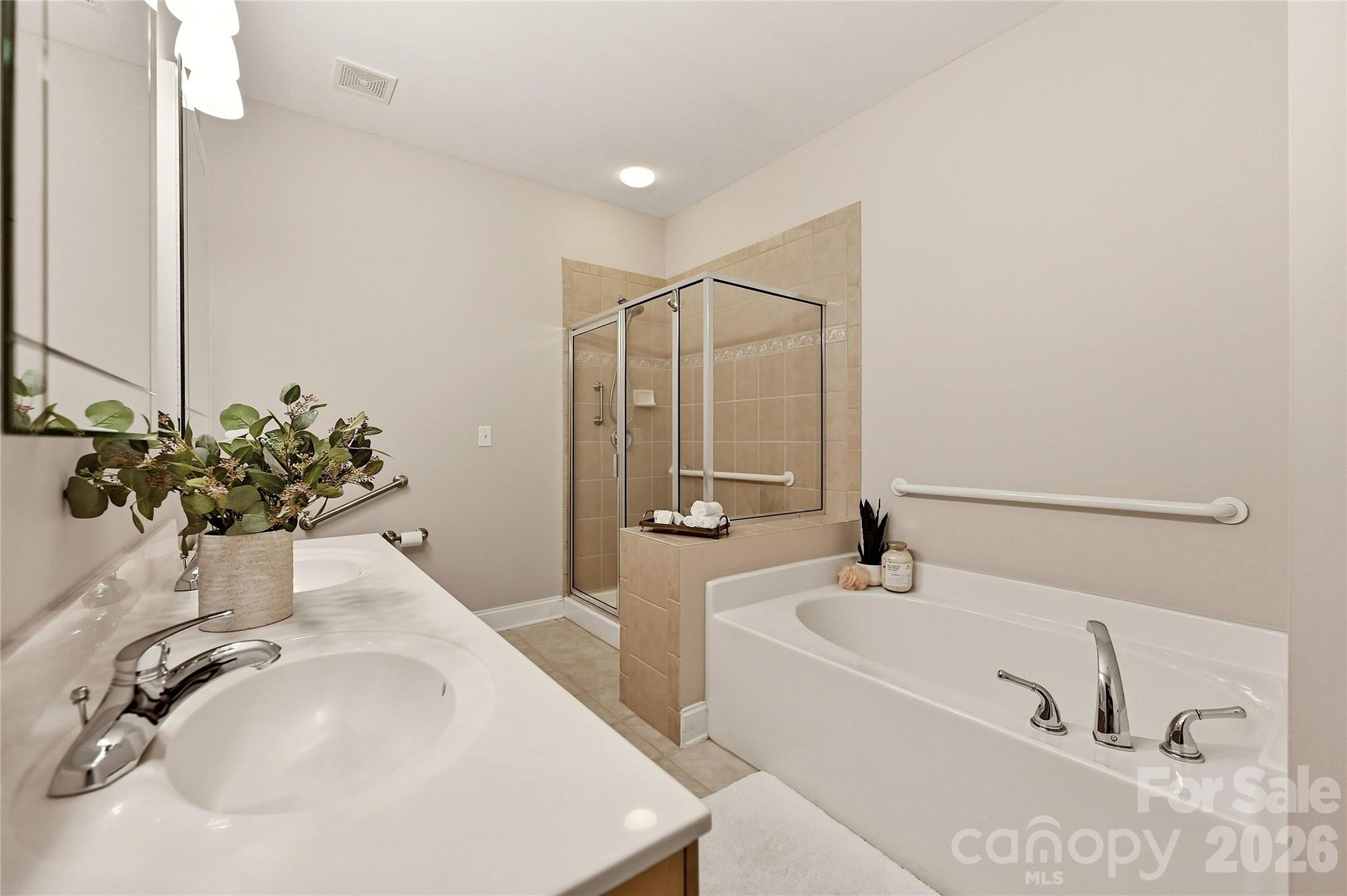 Additional primary bath view highlights the separate shower, garden tub, dual vanity, and accessibility features. - 9009 Rosalyn Glen Road, Cornelius
