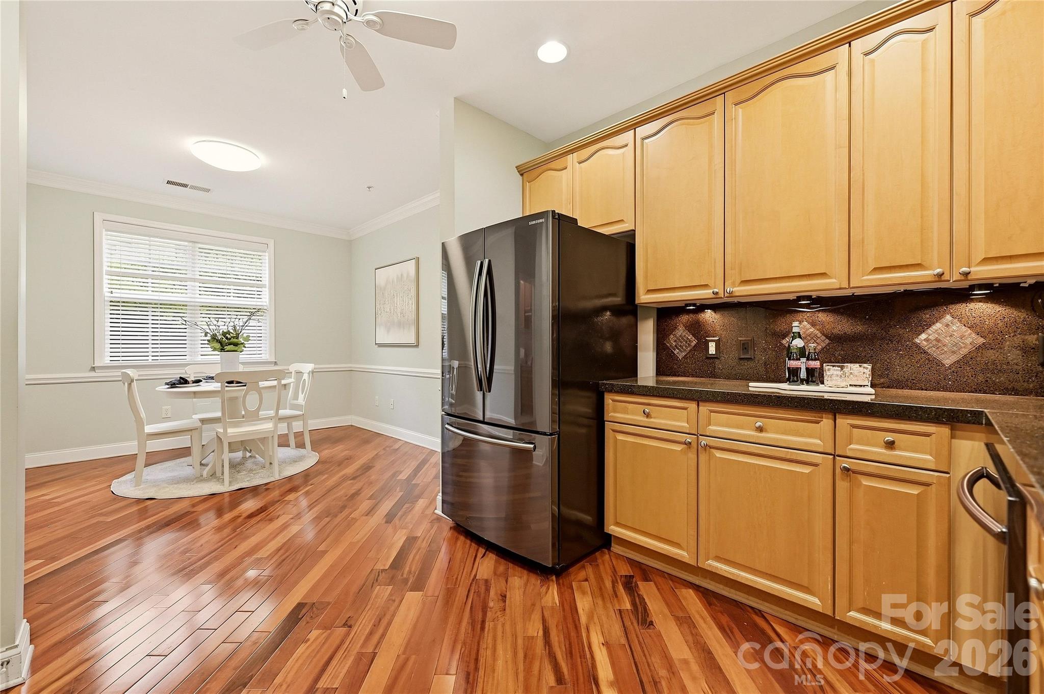 Well-appointed kitchen offers abundant cabinet storage, stainless steel appliances, and convenient access to the dining area. - 9009 Rosalyn Glen Road, Cornelius