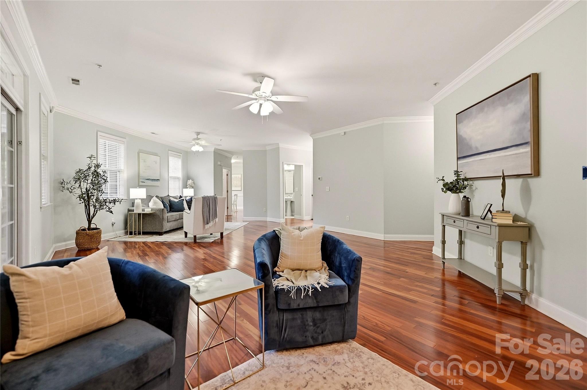 Open living space provides a seamless flow between the sitting area, living room, and screened outdoor living space. - 9009 Rosalyn Glen Road, Cornelius