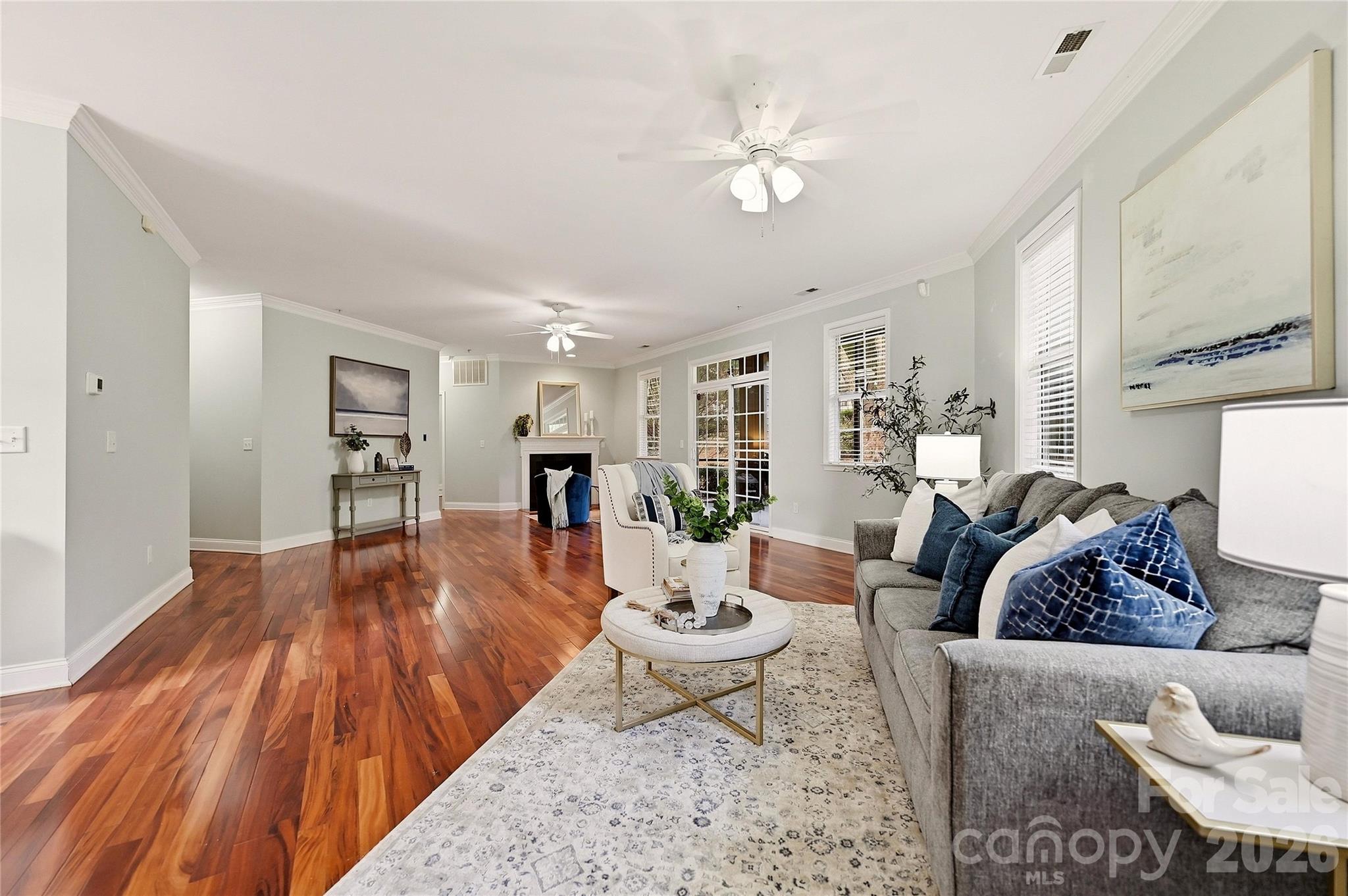 Spacious open living area offers hardwood flooring, a cozy gas-log fireplace, and plenty of room for comfortable everyday living. - 9009 Rosalyn Glen Road, Cornelius