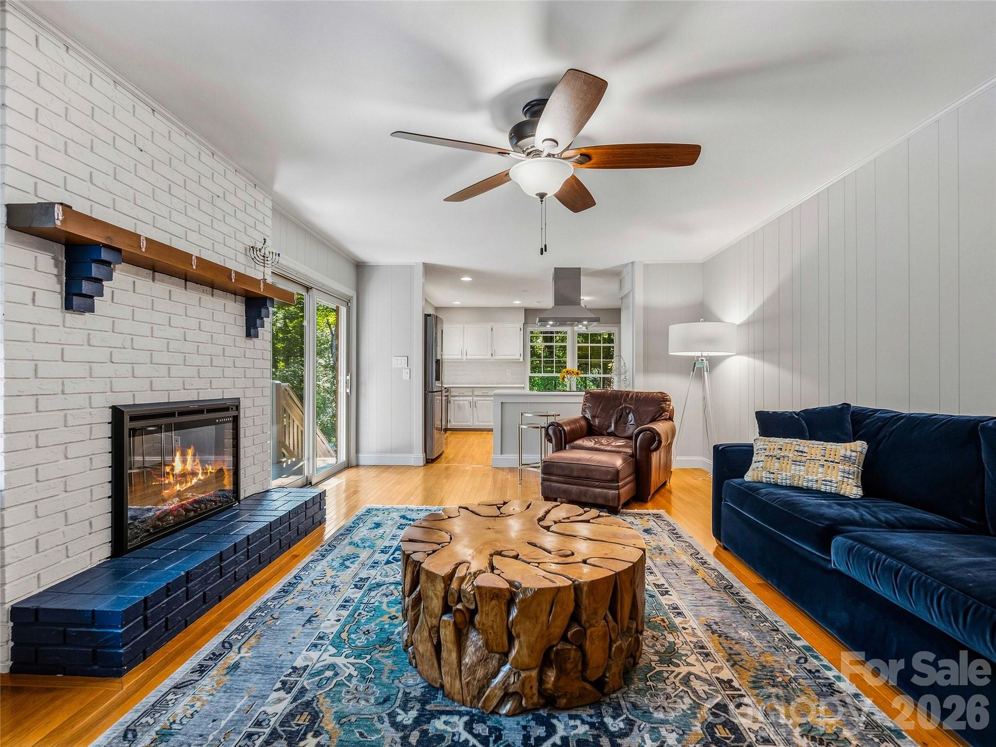 Den with fireplace and deck access off kitchen. - 531 Bluebird Ridge, Asheville