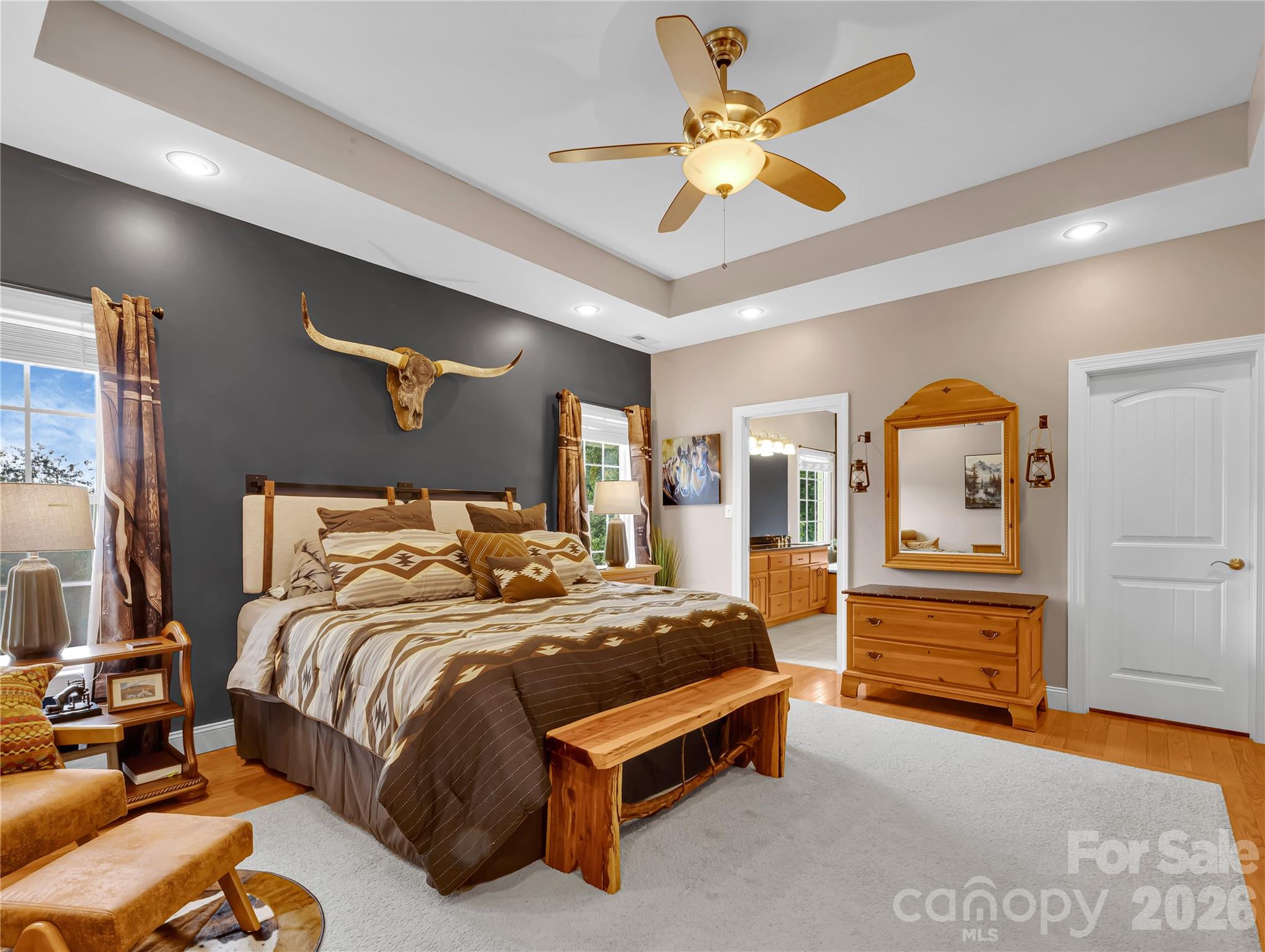 Spacious primary bedroom with 2 big walk in closets, and a spacious en suite bath with a shower and a soaking tub. Laundry is located right next to this suite for ultimate convenience. - 27 & 56 Troy Lane, Tryon