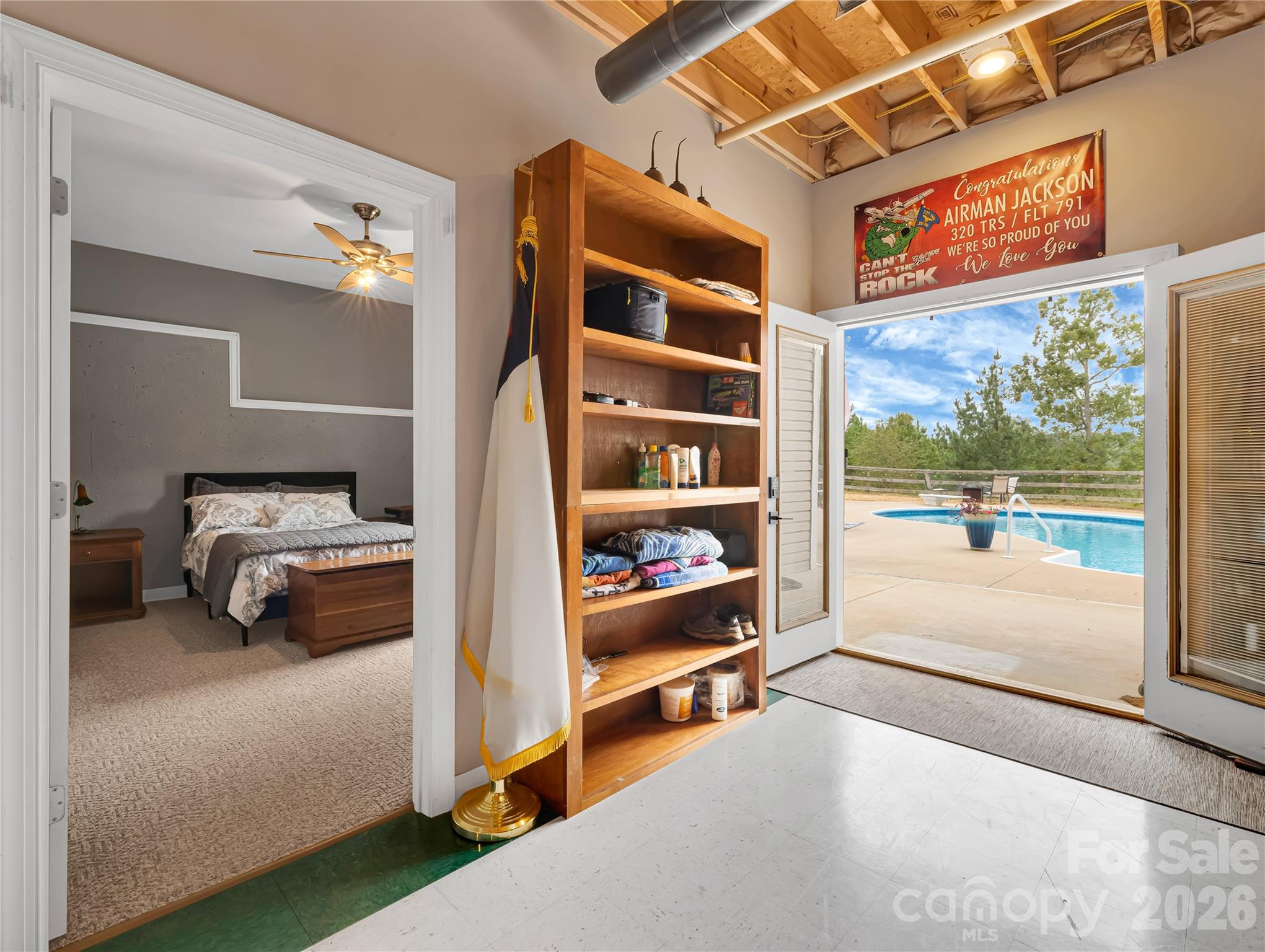 Guest bedroom and double doors out to the patio and pool area. There is also a jacuzzi/hot tub built in to the patio area. Pool and hot tub are both heated. - 27 & 56 Troy Lane, Tryon