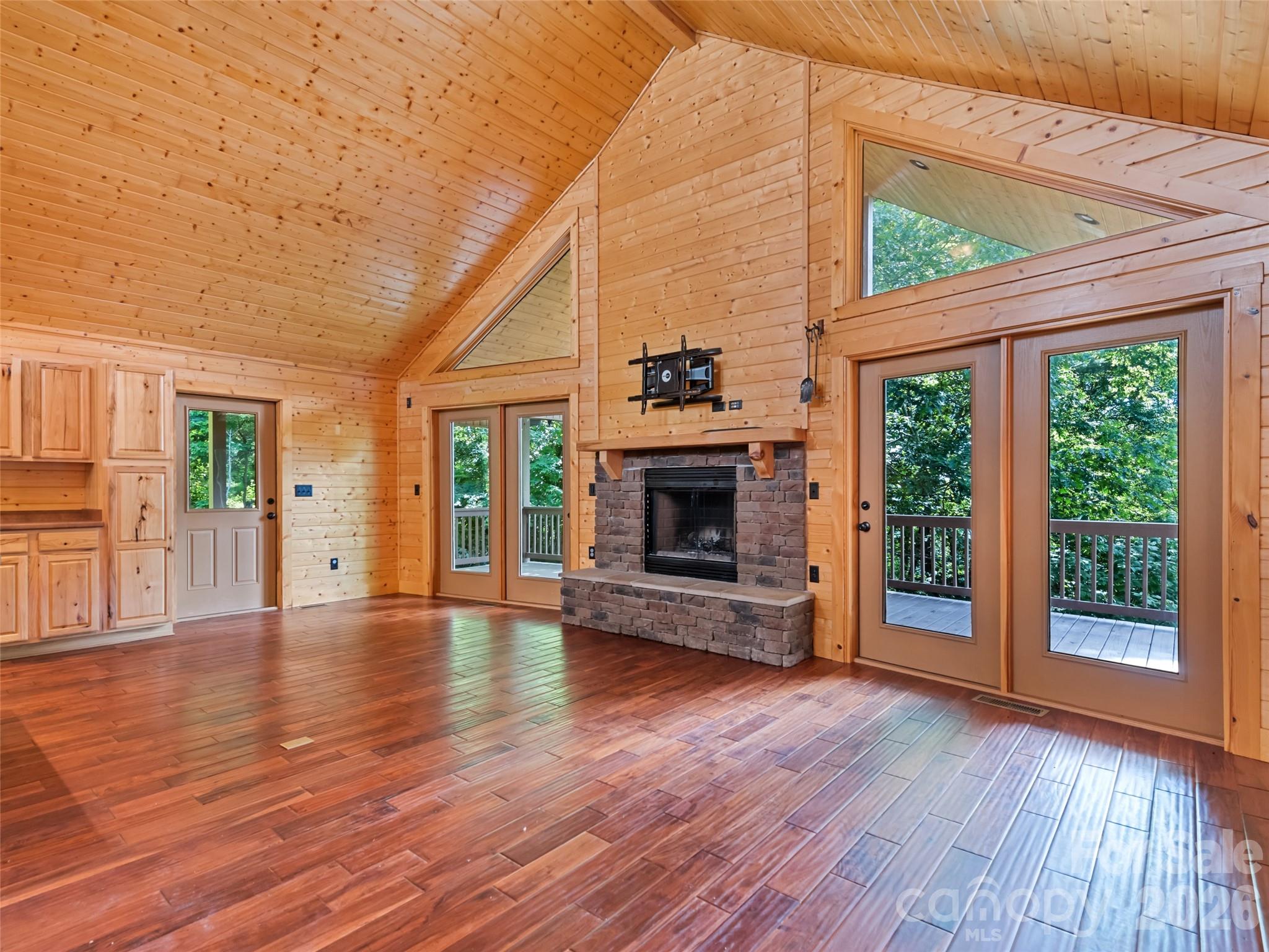 Cathedral ceilings and a wooded setting frame the great room - 51 Stony Pond Lane, Canton