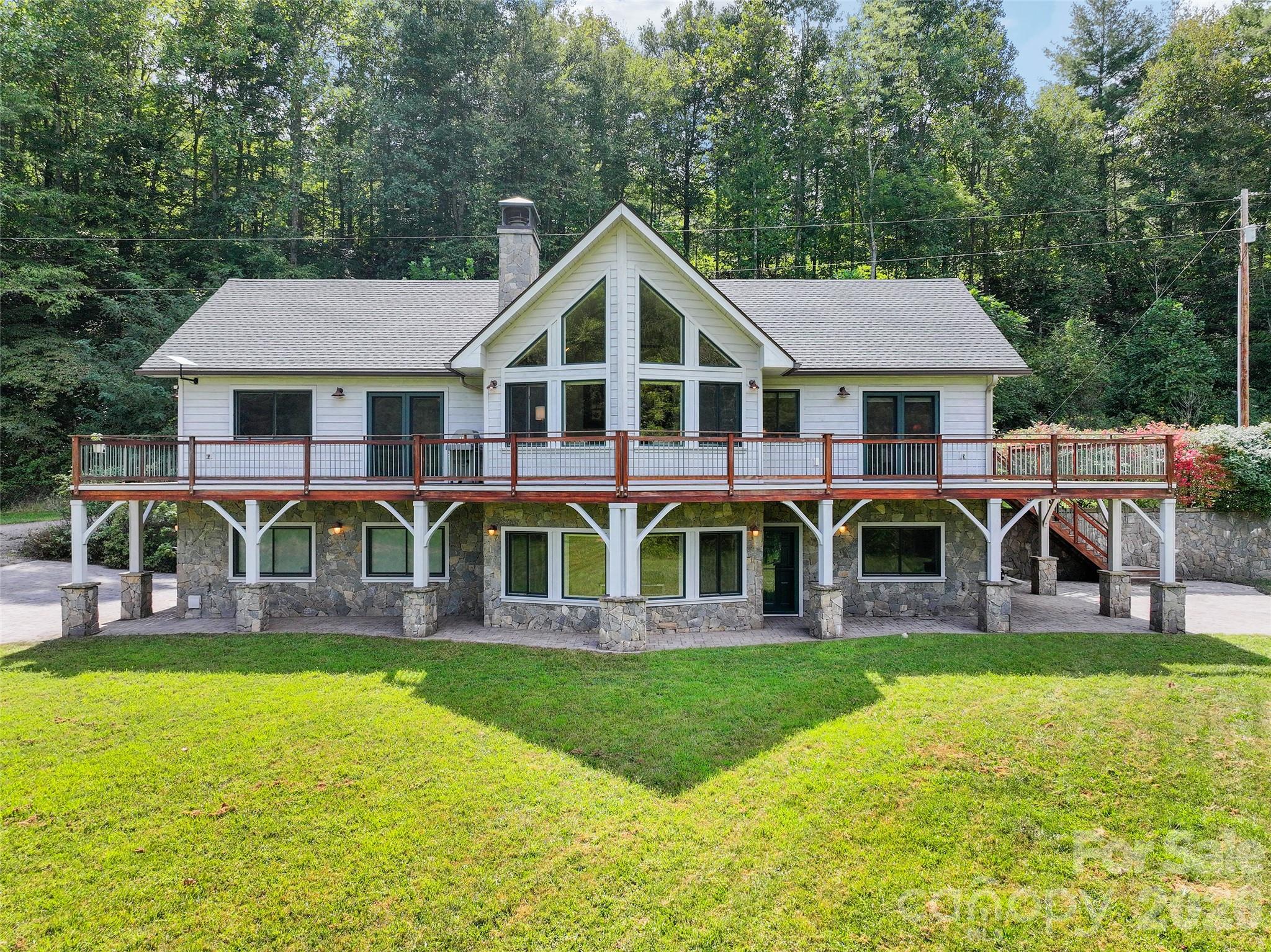 Distinctive residence featuring cypress siding, vaulted architecture and expansive wrap-around decking. - 174b Marina Cove, Waynesville