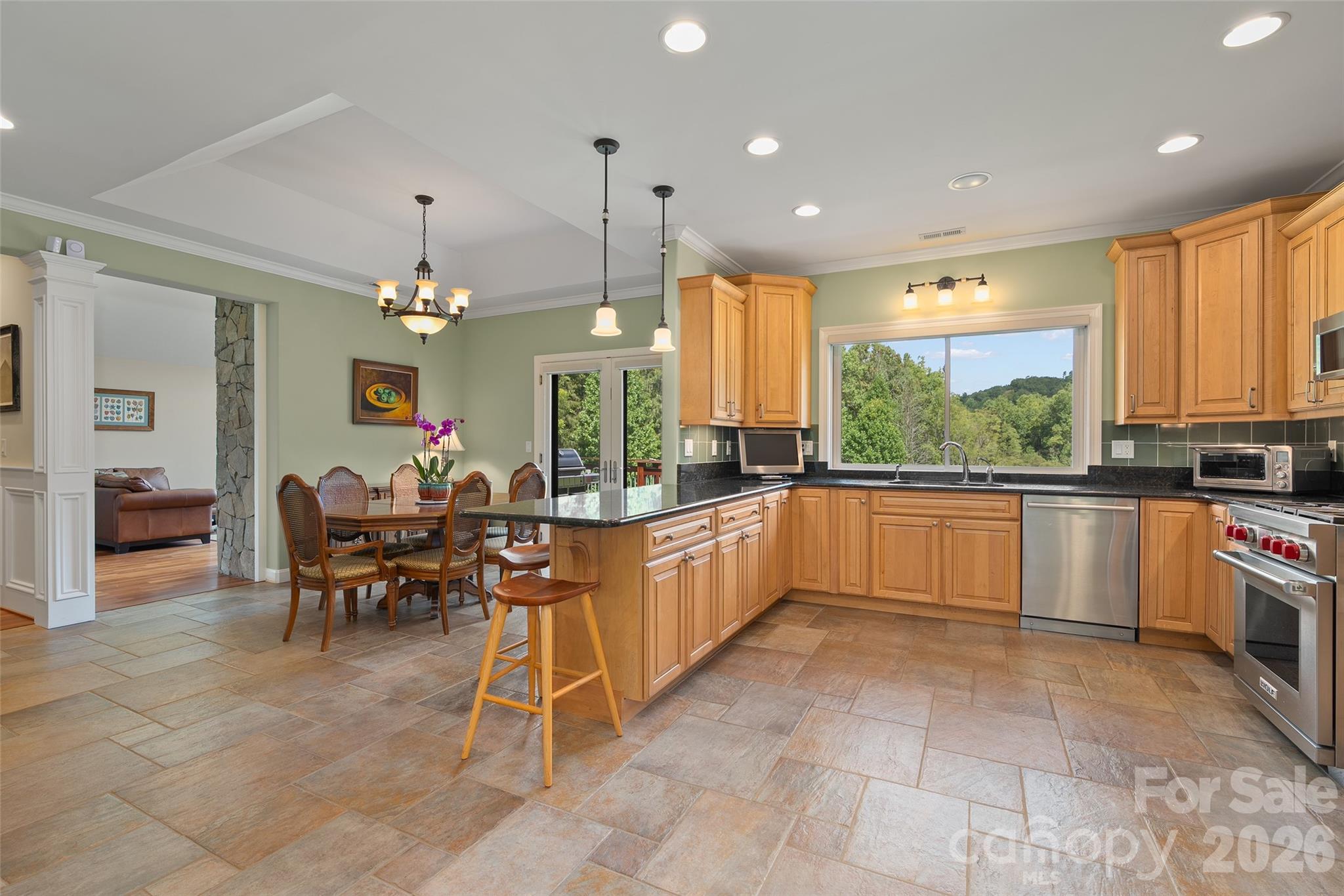 Open kitchen and dining areas create an easy flow for gathering with family and friends. - 174b Marina Cove, Waynesville