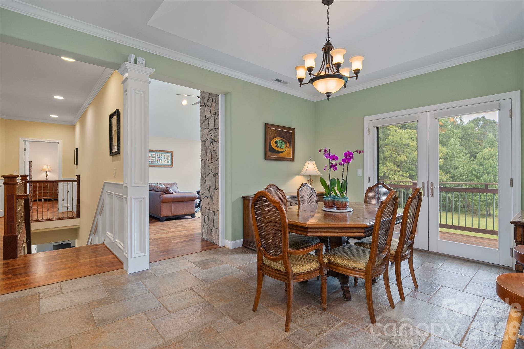 The dining area features tray ceiling detail and beautiful views of the surrounding property. - 174b Marina Cove, Waynesville