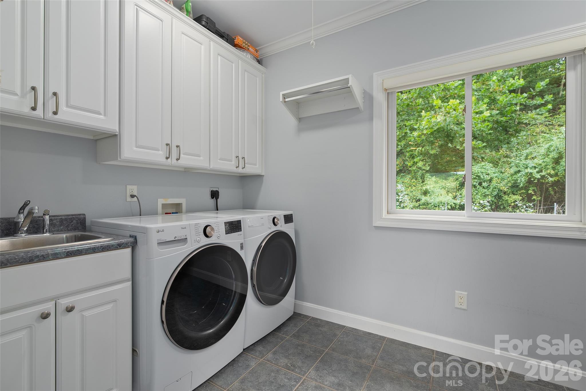 Dedicated laundry room with cabinetry, utility sink and updated washer and dryer. - 174b Marina Cove, Waynesville
