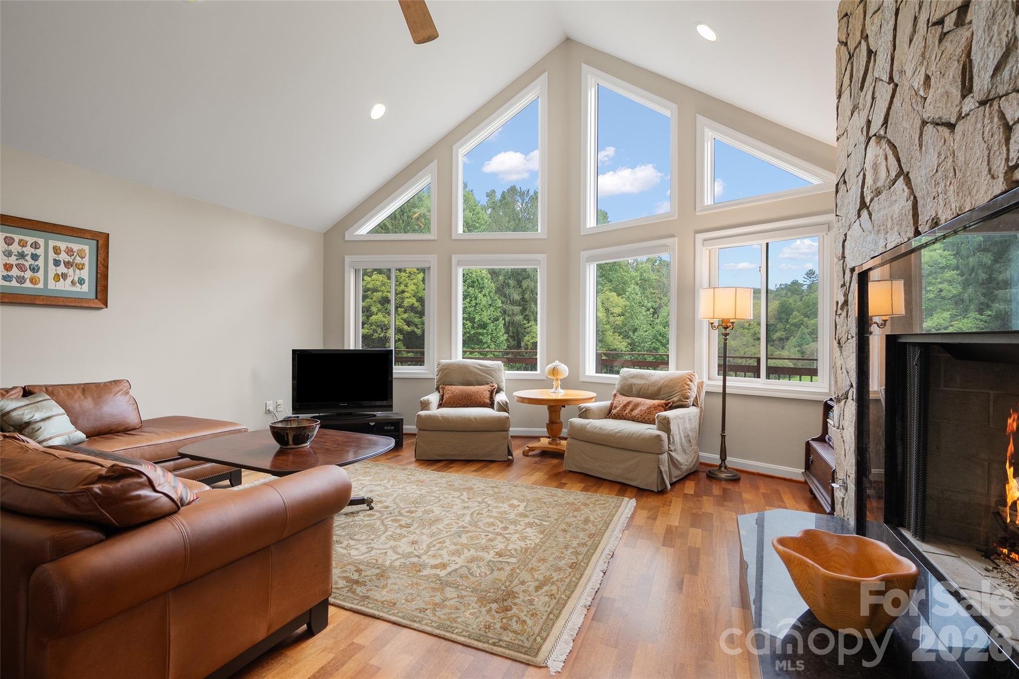 Soaring vaulted ceiling and dramatic windows fill the great room with natural light. - 174b Marina Cove, Waynesville