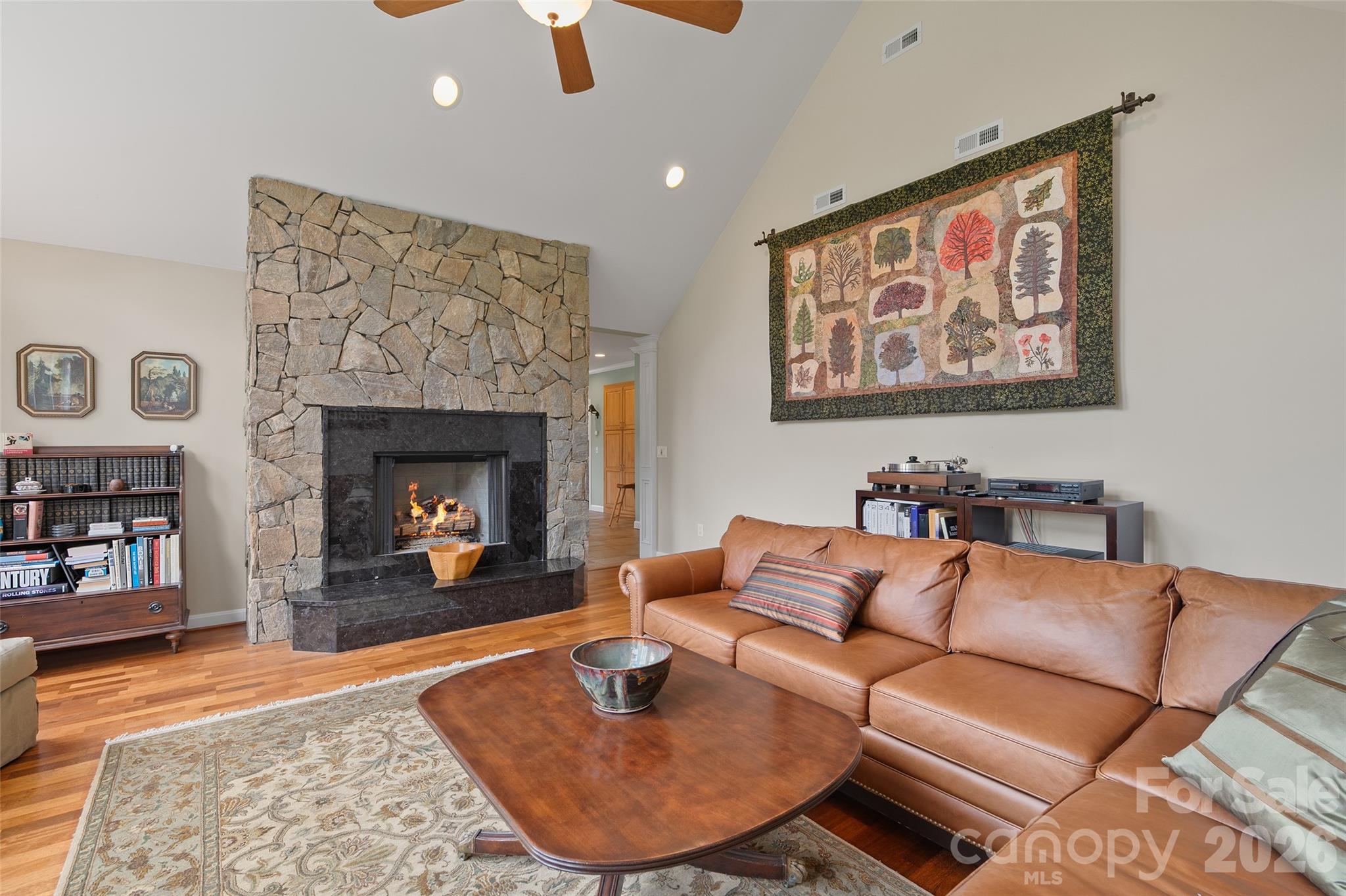 Stone fireplace anchors the spacious living room and adds classic mountain character. - 174b Marina Cove, Waynesville