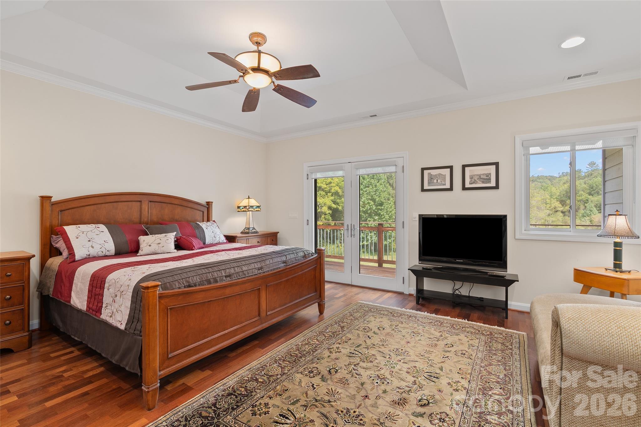 Primary bedroom offers generous proportions, hardwood flooring and direct access to the bath. - 174b Marina Cove, Waynesville
