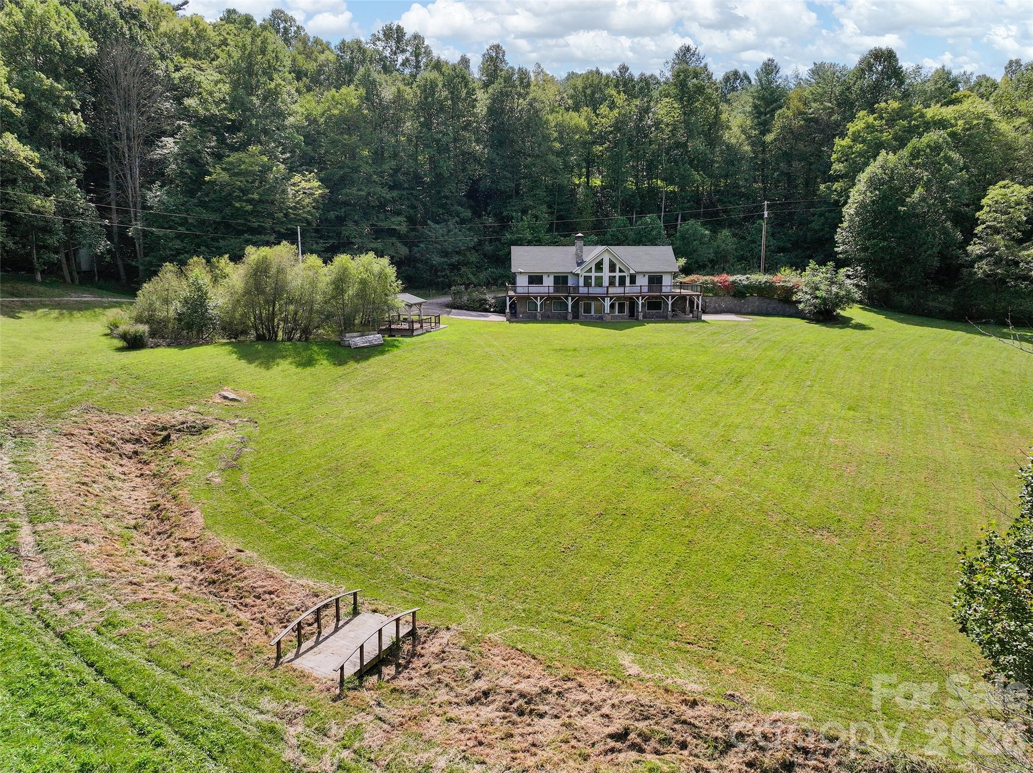 Aerial view of the main house and stream bed that separates the lawn from the meadow." - 174b Marina Cove, Waynesville