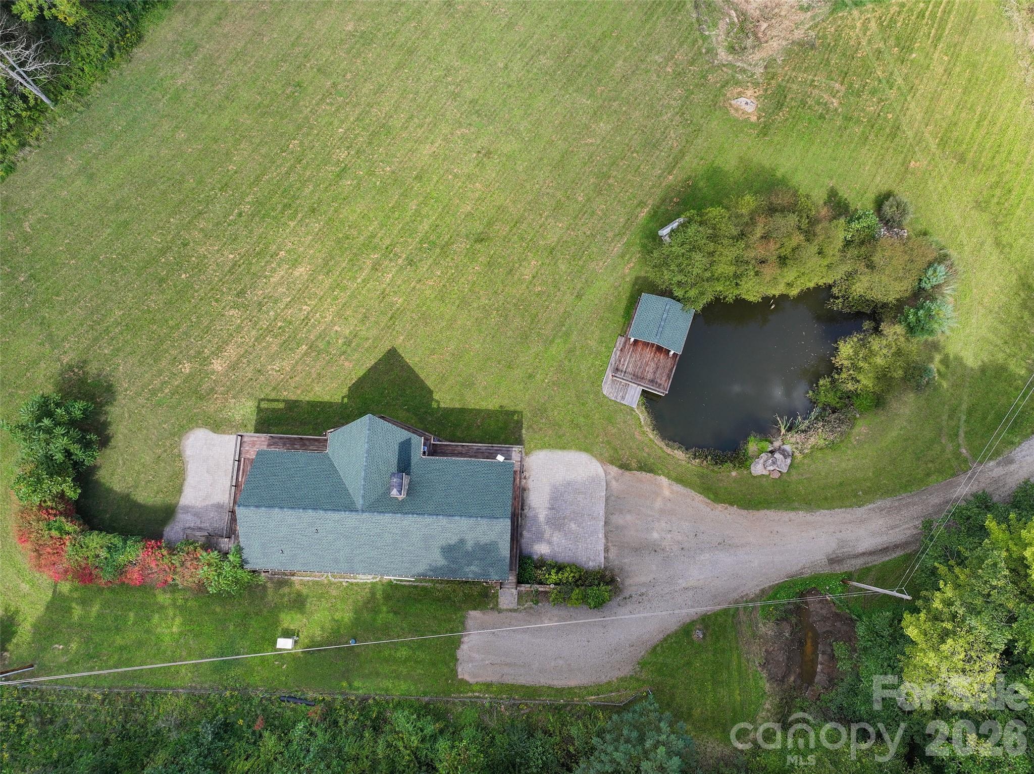 Aerial view highlights the main residence, expansive lawn and private pond. - 174b Marina Cove, Waynesville