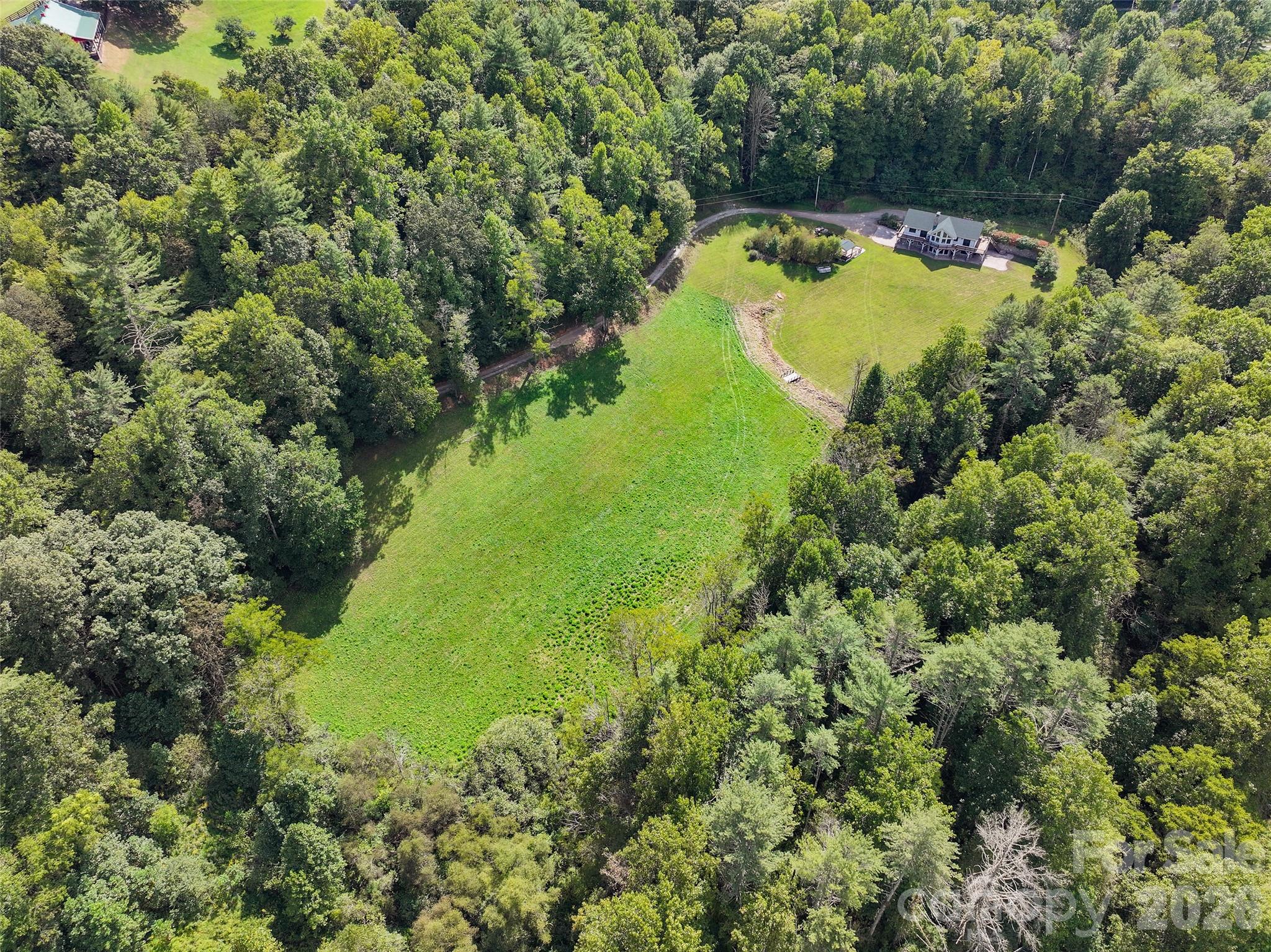 Aerial view showcases the expansive 5.016 acres surrounding the residence. - 174b Marina Cove, Waynesville