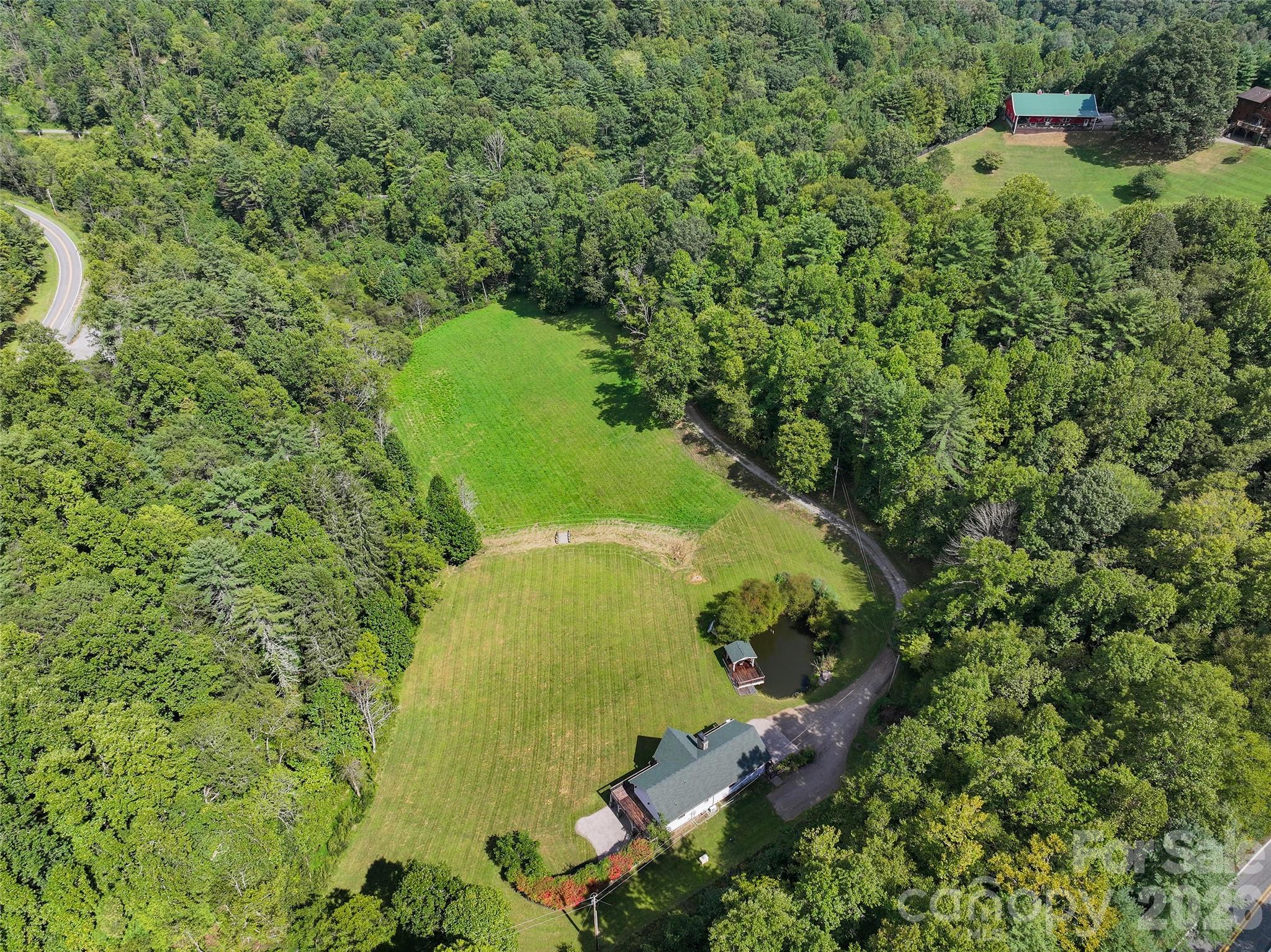 A rare combination of open acreage, wooded surroundings, and a private pond. - 174b Marina Cove, Waynesville