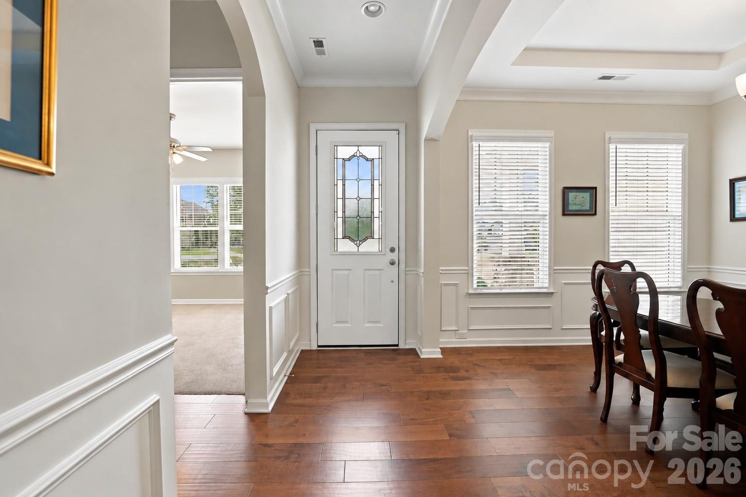 Inviting entry with wide-plank hardwood floors, detailed millwork, graceful archways and an elegant lead-glass front door. - 8504 Hope Run Court, Indian Land