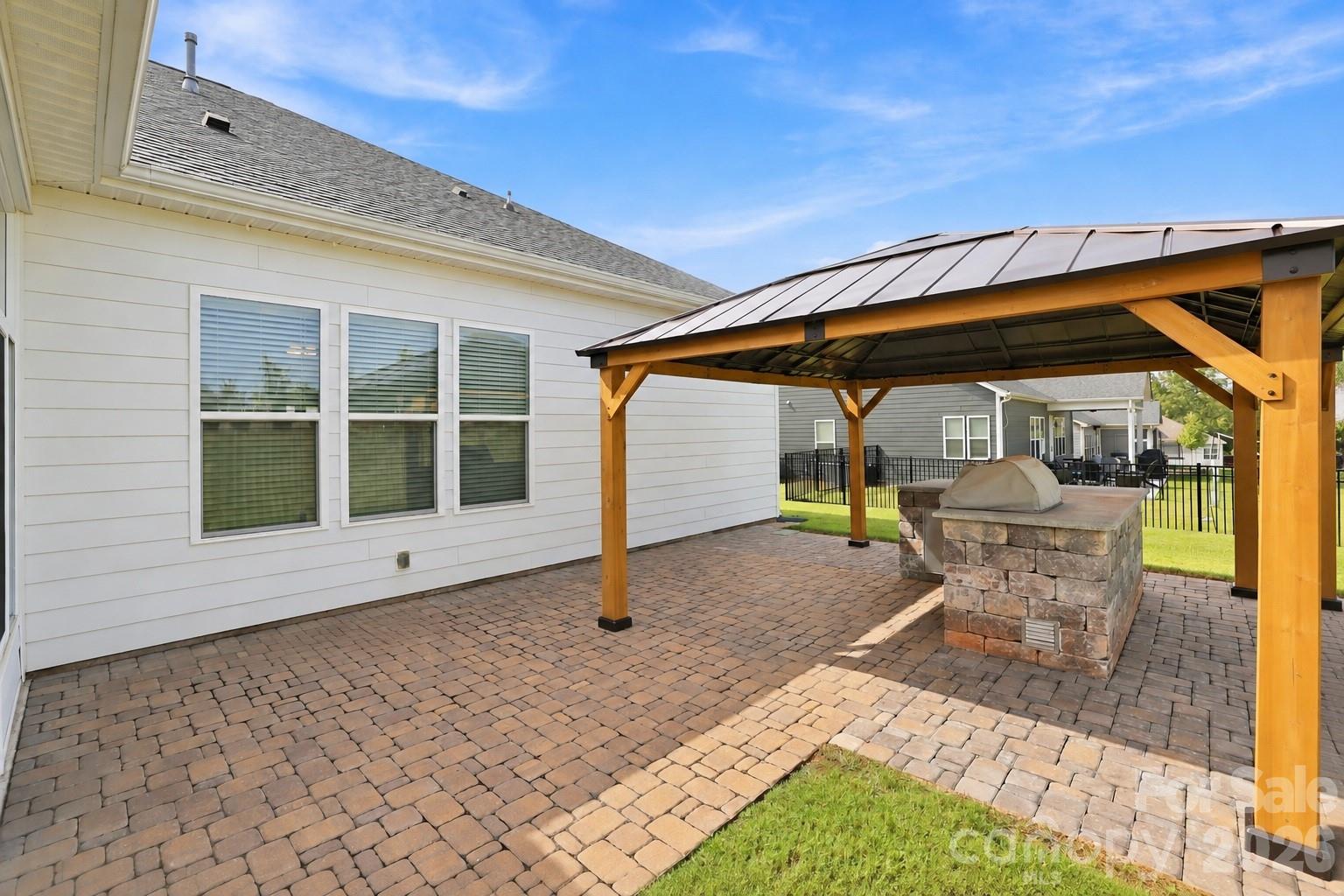 Patio area with built-in grilling center, custom gazebo, brick pavers extend the home's living and entertaining space. - 8504 Hope Run Court, Indian Land