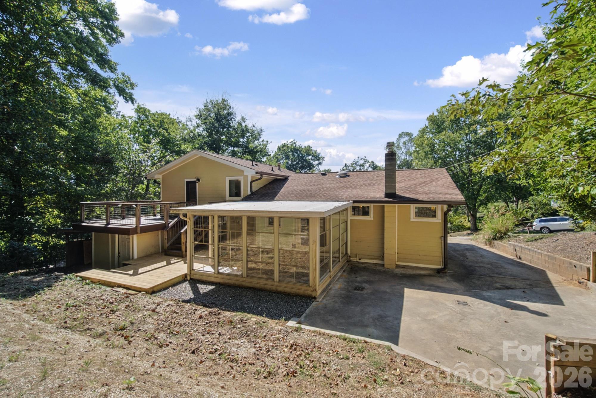 Showing sunroom with parking area in the back/side - 35 Clement Drive, Asheville