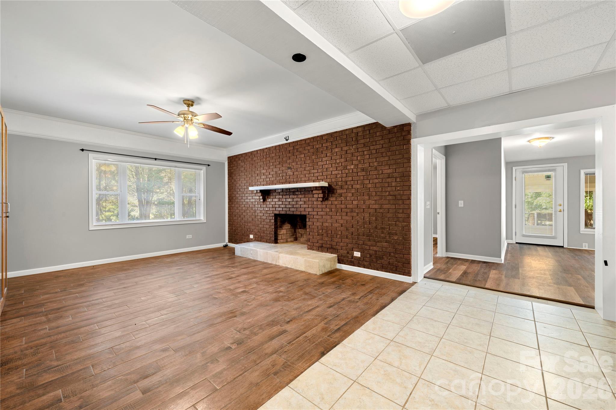 Basement level living room/den with wood burning fireplace - adjacent to dining and full kitchen - 109 Woodside Avenue, Gastonia