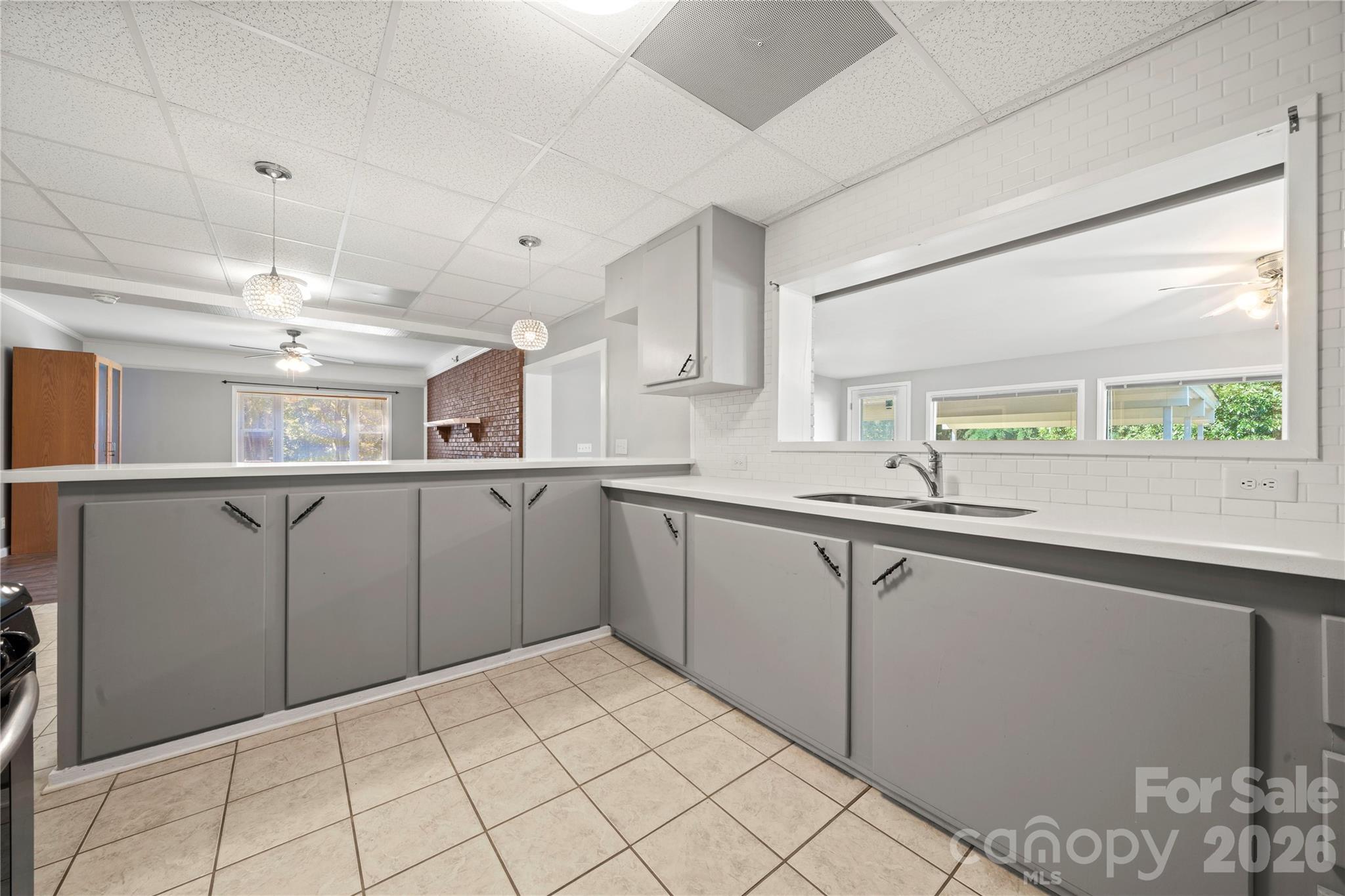 Basement level full kitchen that overlooks the entryway room and dining area - 109 Woodside Avenue, Gastonia