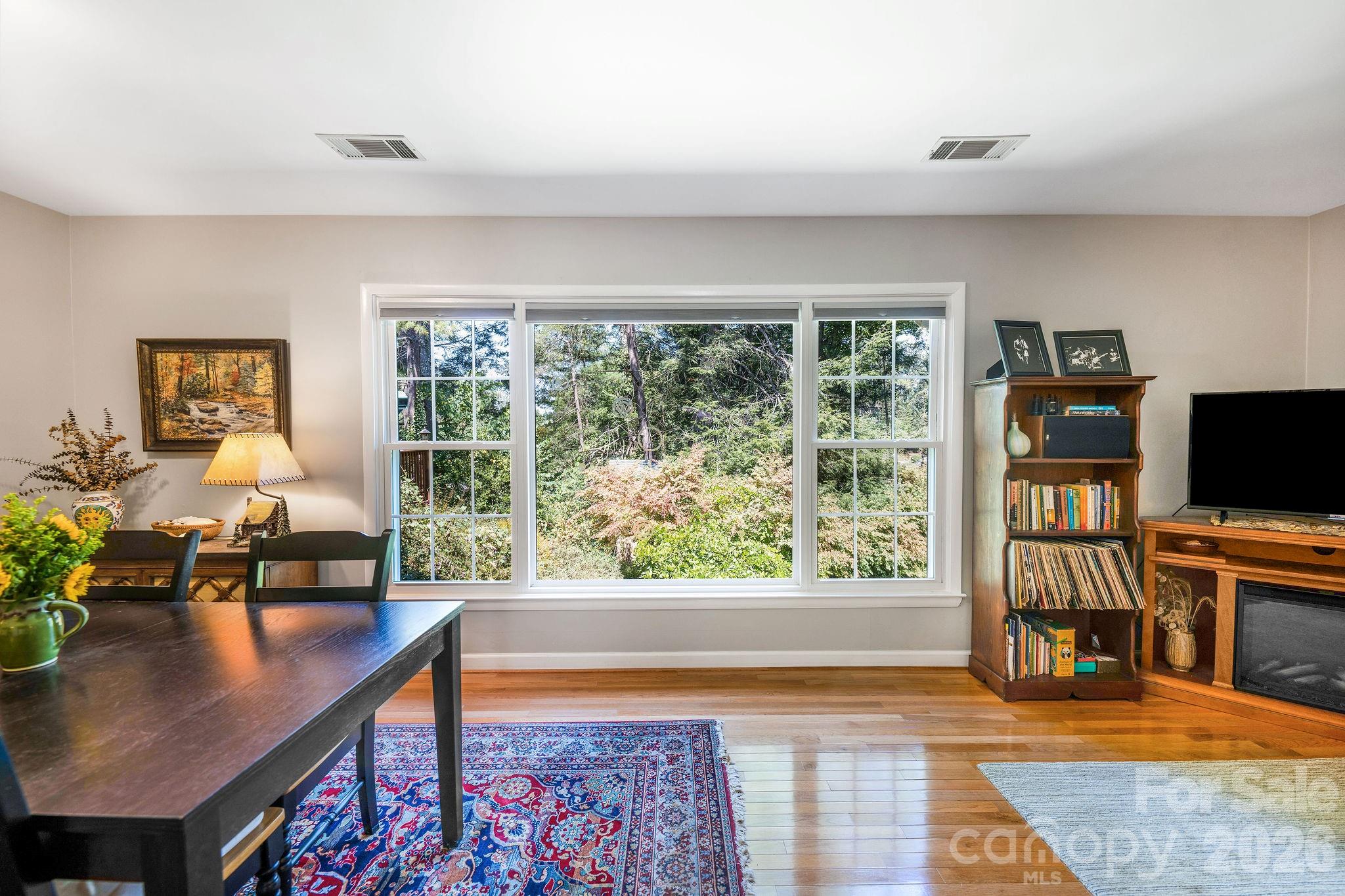 More large windows let in the nature and light. - 1 Pheasant Ridge Drive, Asheville