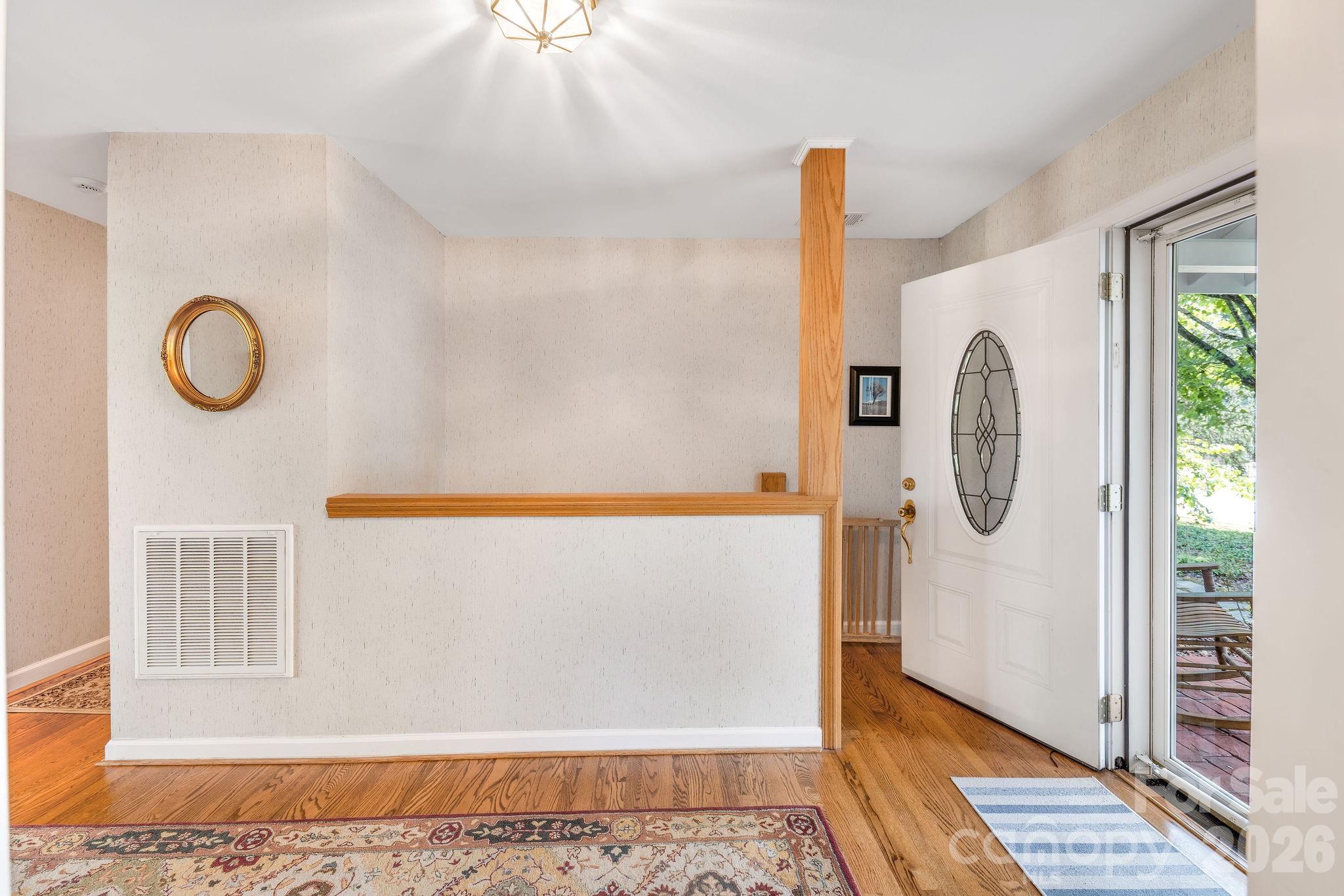 Entry hall, with stairs to second living space downstairs. - 1 Pheasant Ridge Drive, Asheville