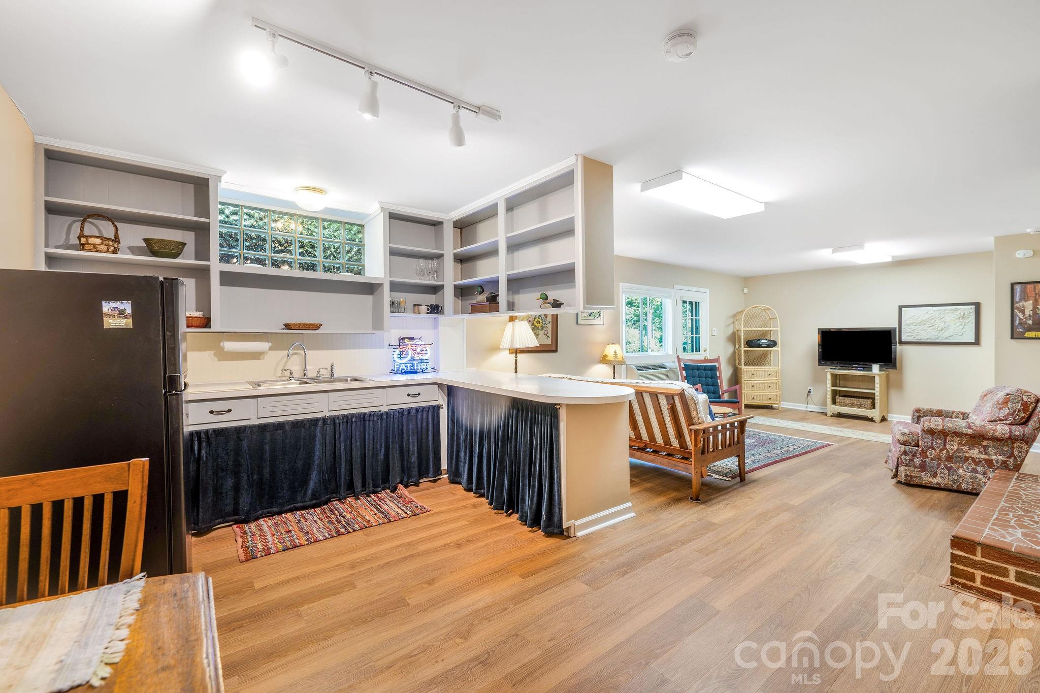 Lower level living quarters has second living room with gas fireplace, kitchenette, and 2 additional bonus rooms. - 1 Pheasant Ridge Drive, Asheville