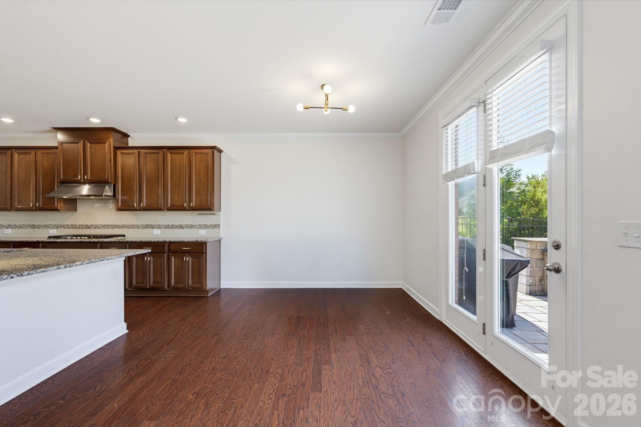 The breakfast area sits beside backyard doors, creating a sunny place for quick breakfasts, after-school snacks, and easy patio access. - 8315 Breton Way, Harrisburg