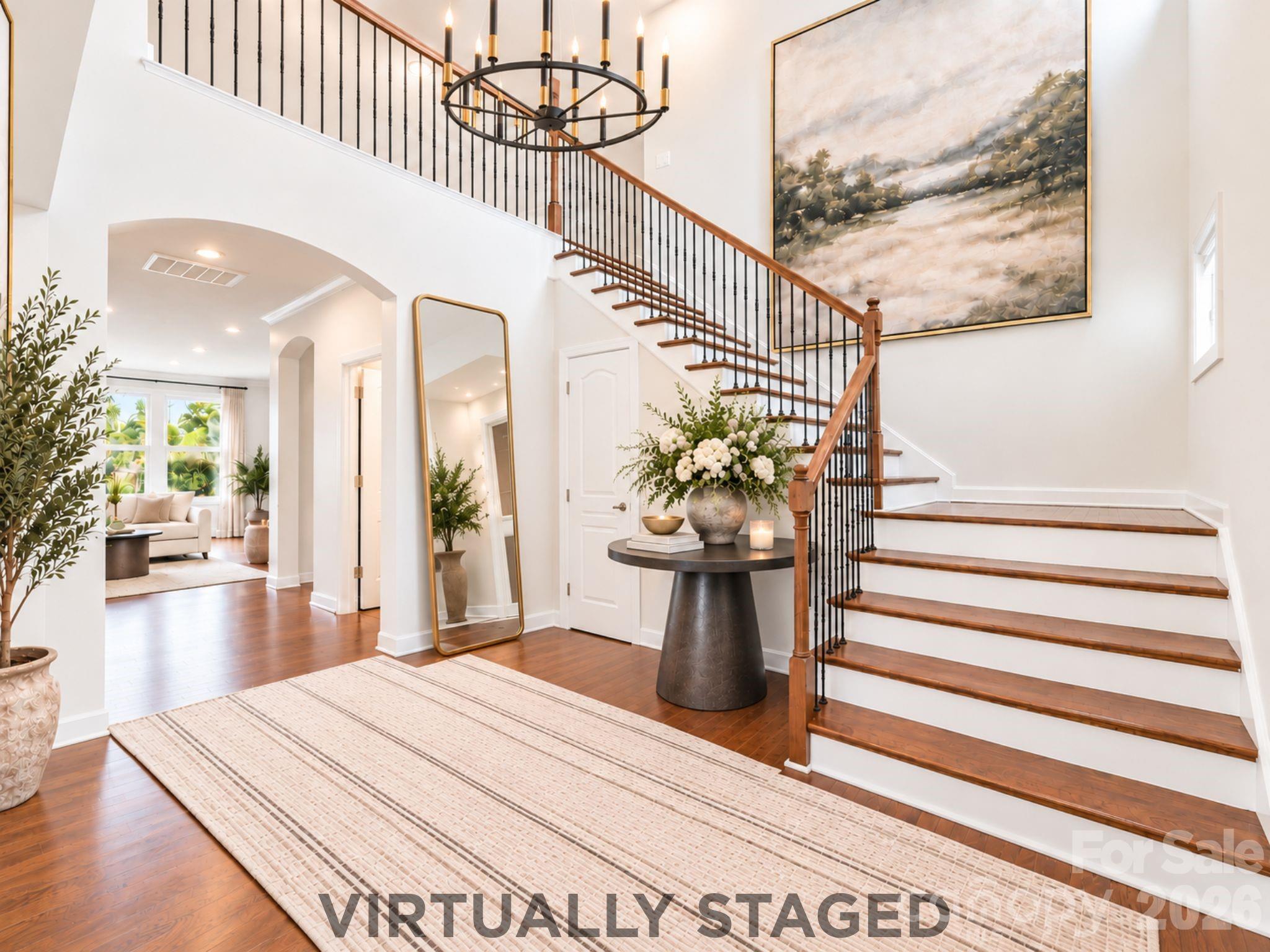Virtually staged, the soaring foyer reveals its potential as an elegant introduction to the home, where thoughtfully placed furnishings complement the graceful staircase and create a warm, memorable sense of arrival. - 8315 Breton Way, Harrisburg