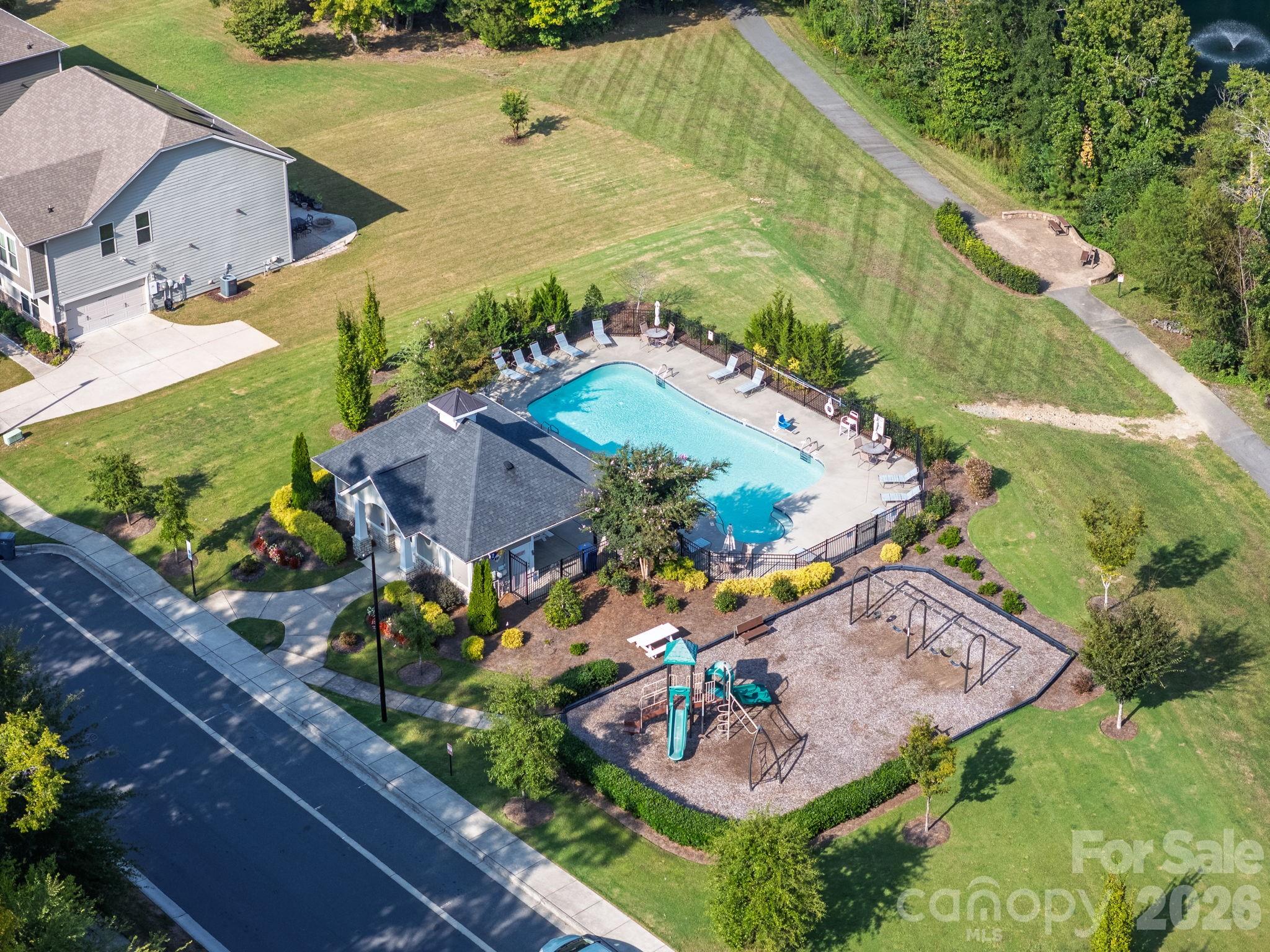 An aerial view brings the Churchill Farms amenities together, including the pool, cabana, playground, and surrounding green space. - 8315 Breton Way, Harrisburg