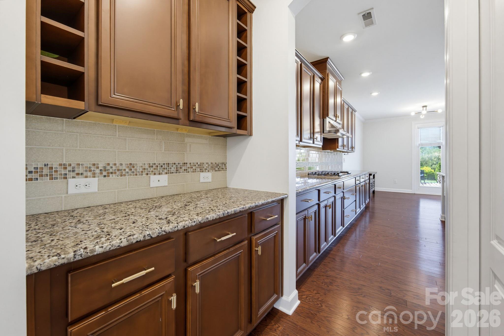 Extra cabinetry and counter space in the butler's pantry, complete with a spacious walk-in pantry closet, between the kitchen and formal dining room extend the kitchen's storage and serving capacity, ideal for a coffee station or entertaining setup. - 8315 Breton Way, Harrisburg