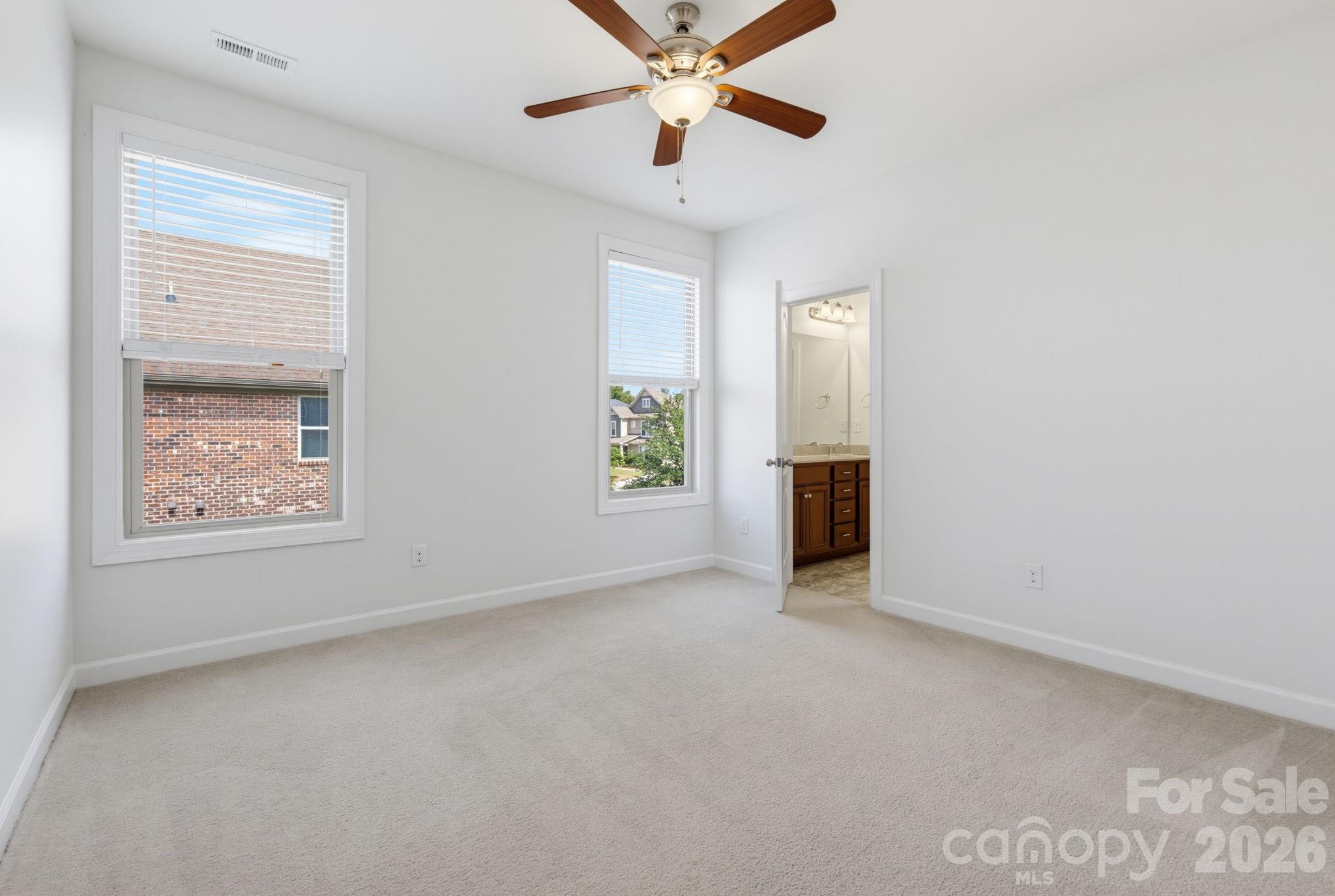 Two generous windows fill this second-level bedroom with natural light, while its comfortable footprint and direct bathroom access create a bright, functional space that can grow and change with the family. - 8315 Breton Way, Harrisburg