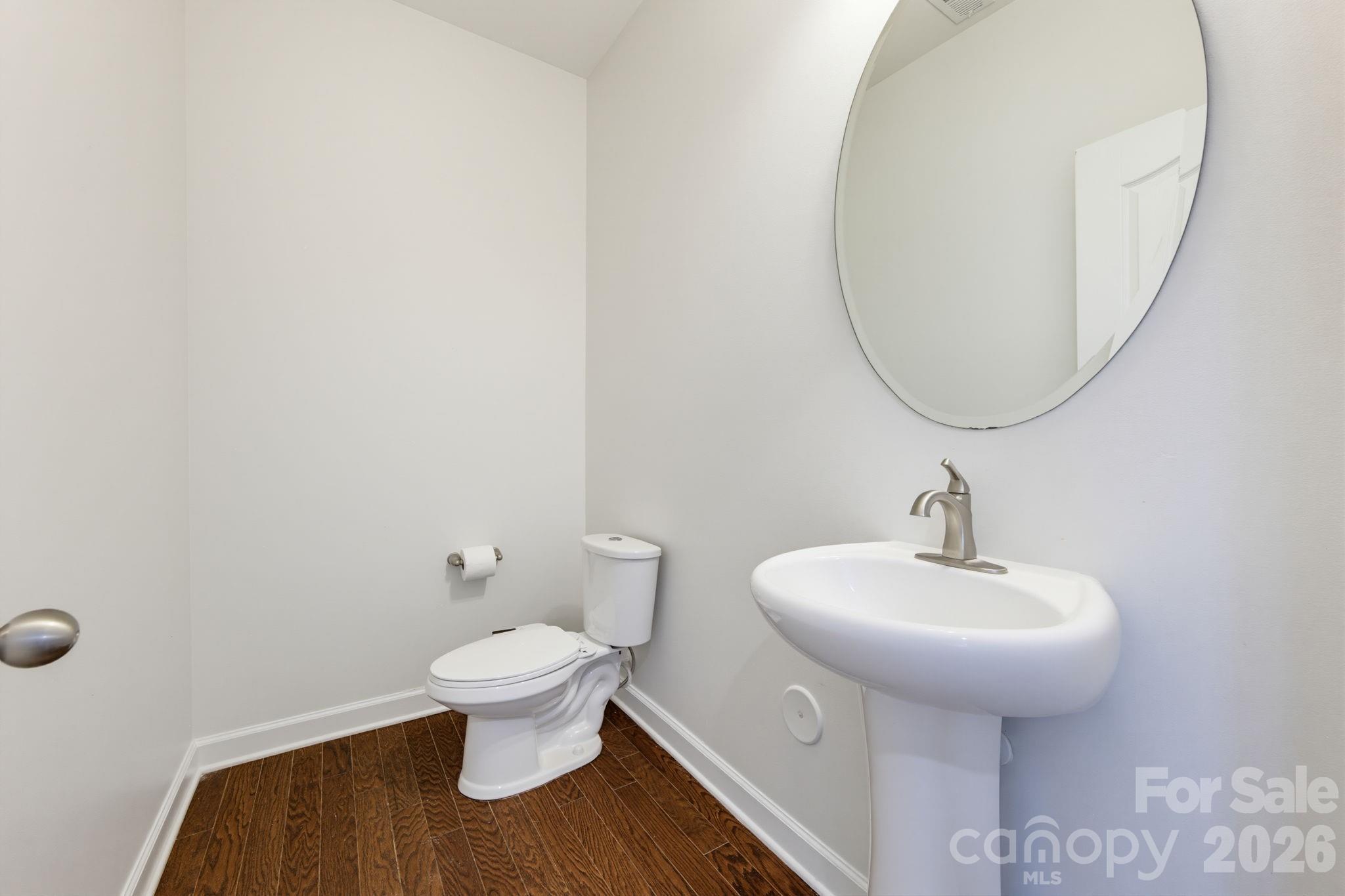 The main-level powder room adds convenience for guests without imposing upon the home's private spaces. - 8315 Breton Way, Harrisburg
