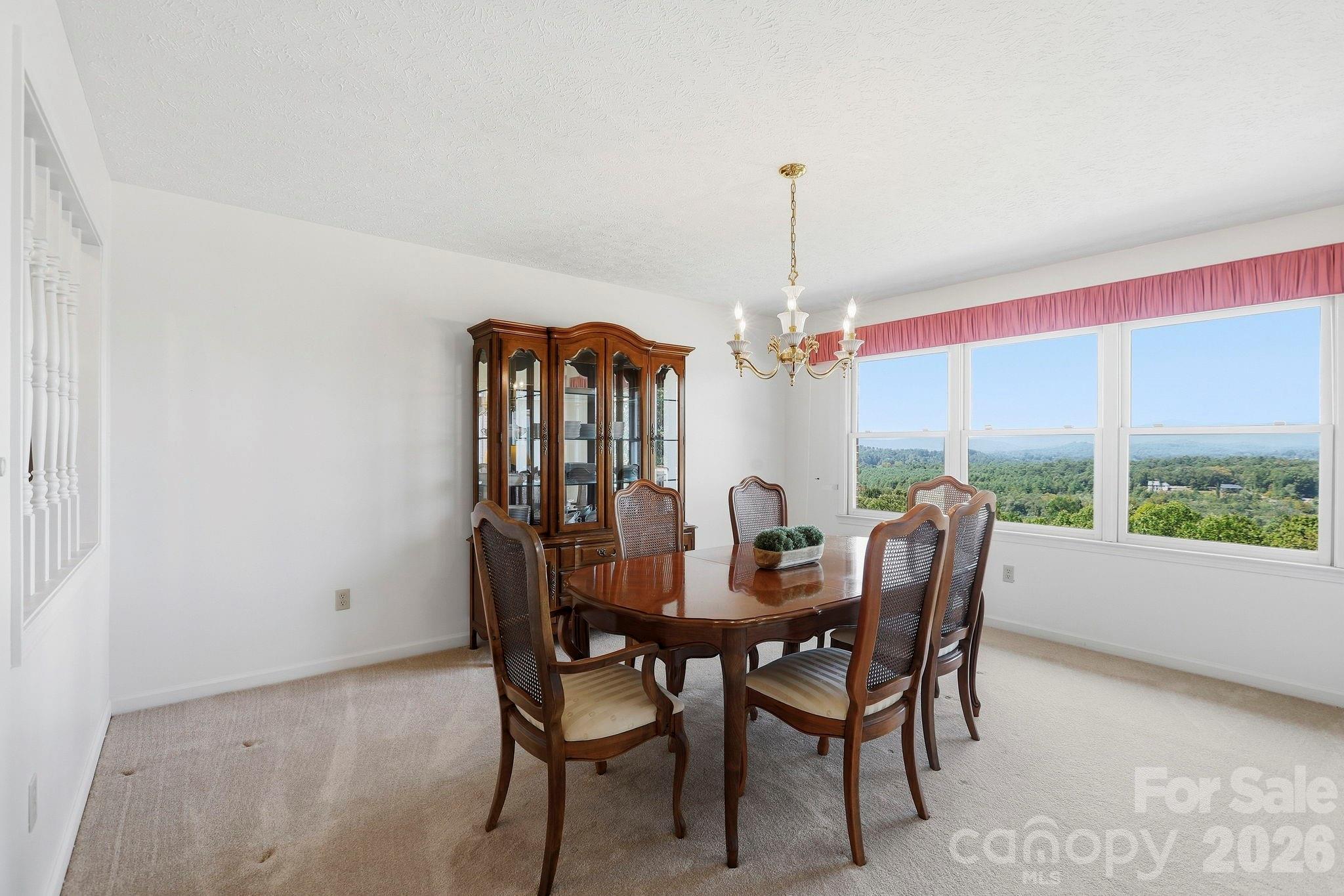 Dining room with western-facing, year-round, layered mountain views - 244 Mountain Valley Drive, Hendersonville