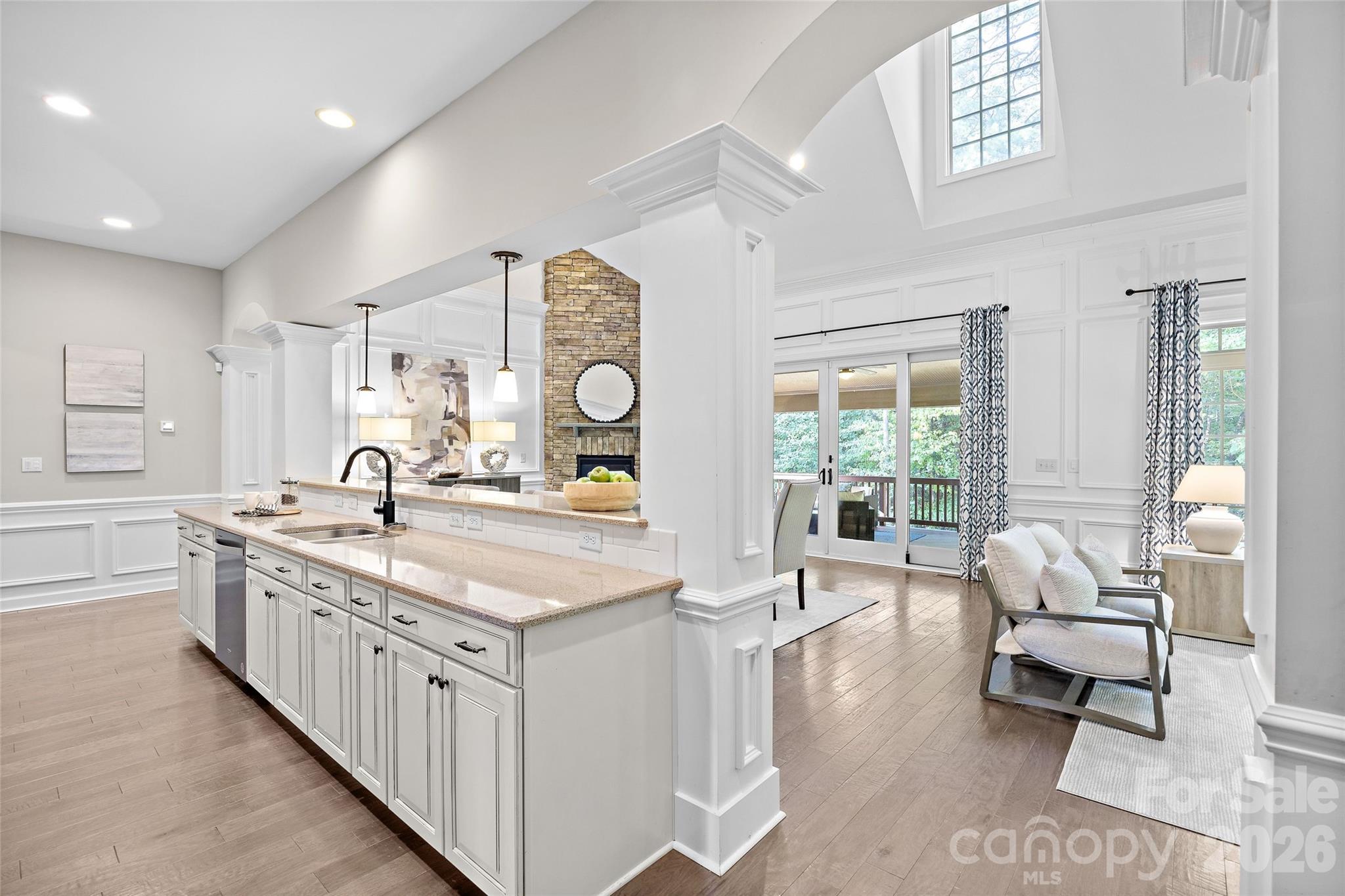 The kitchen is open to the breakfast area and den with a gorgeous vaulted ceiling and lots of windows that overlook a wooded backyard - 1623 Hawkstone Drive, Waxhaw
