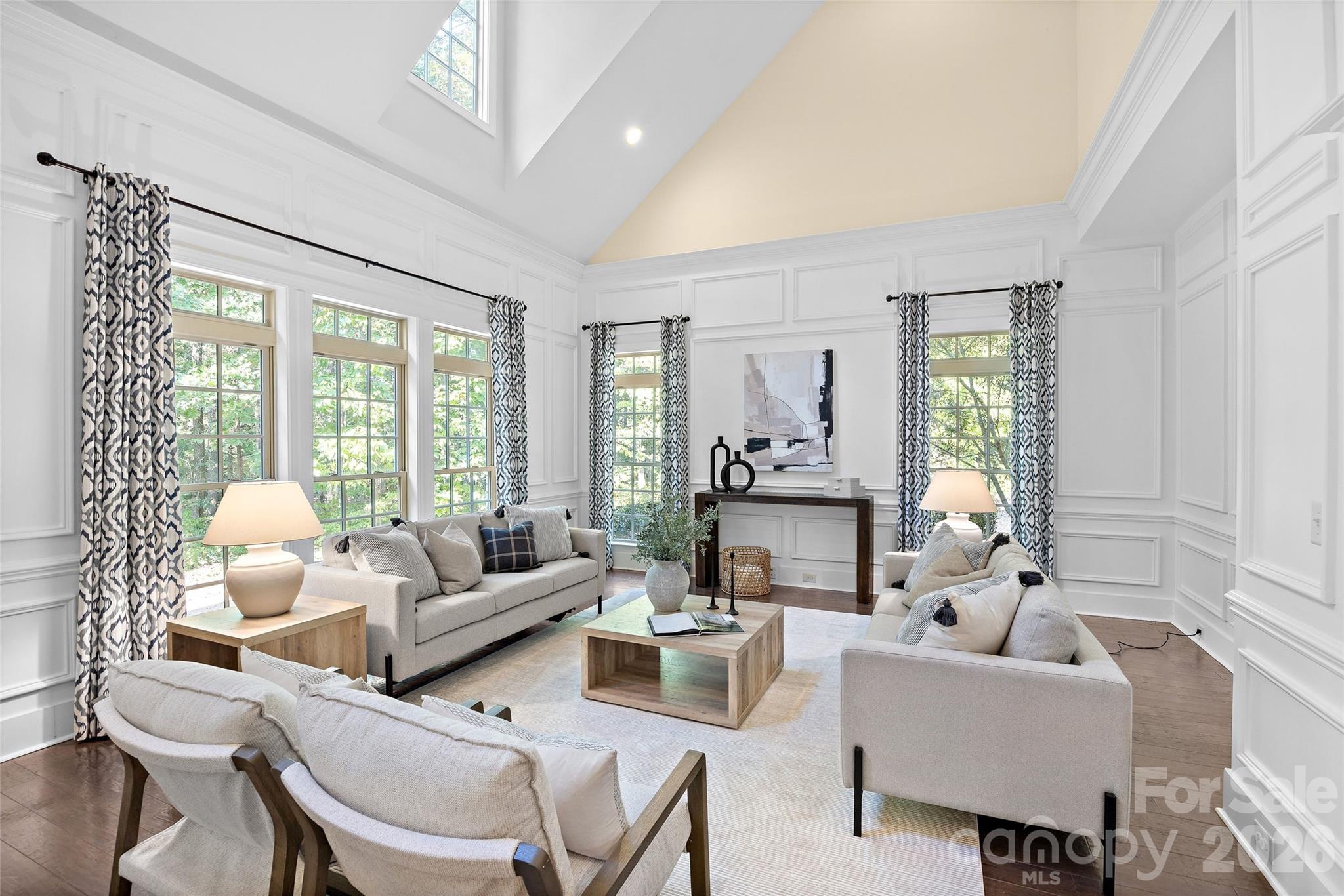 The den features a vaulted ceiling and wall of windows - 1623 Hawkstone Drive, Waxhaw