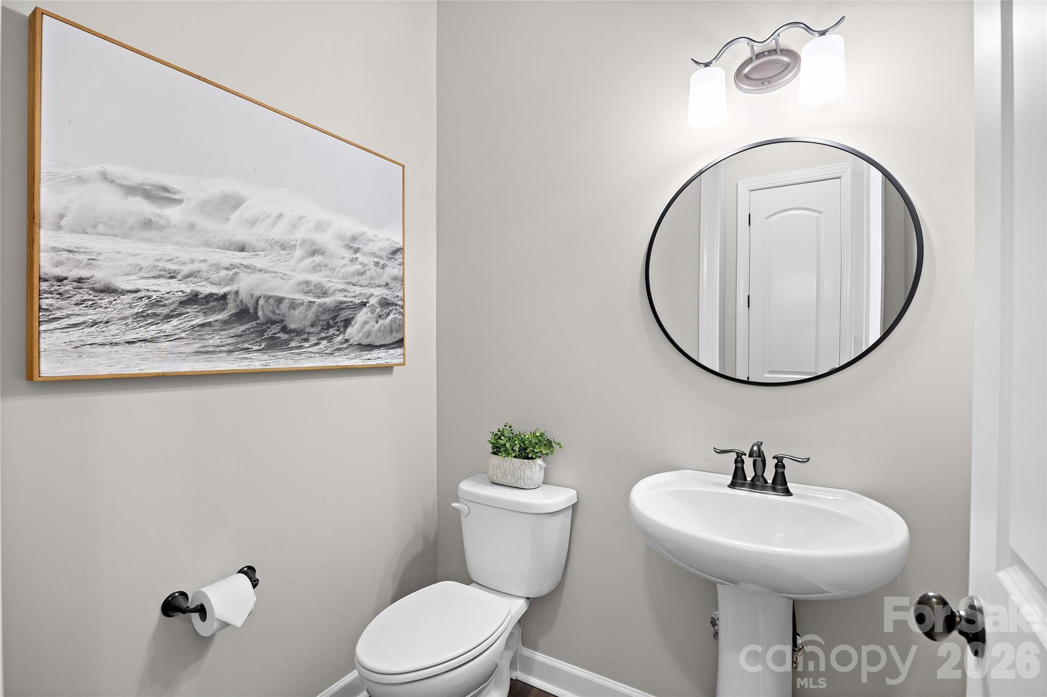 A half bath on the main level is convenient for having guests over and entertaining - 1623 Hawkstone Drive, Waxhaw