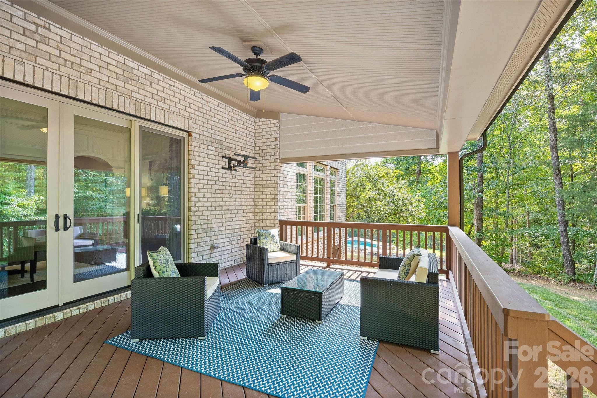 Enjoy a lovely wooded view off of the covered back porch - 1623 Hawkstone Drive, Waxhaw